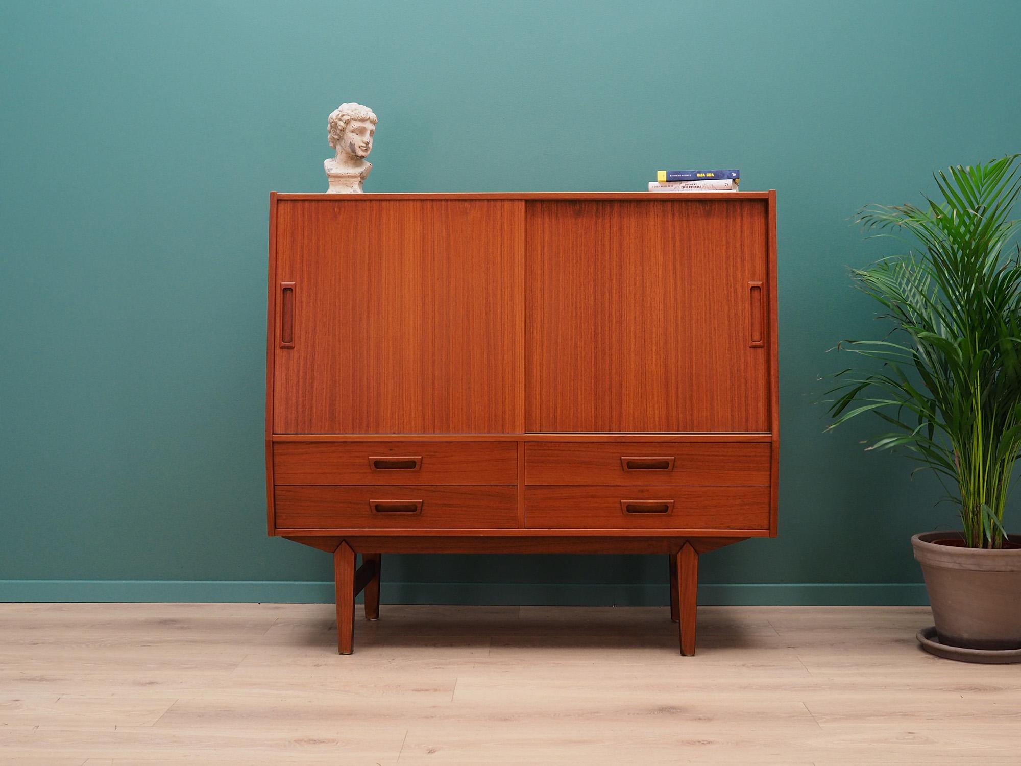 Fantastic highboard from the 1960s-1970s. Scandinavian design, Minimalist form. Manufactured in the Vemb Mobelfabrik. Surface of the furniture finished with teak veneer. Highboard with four packed drawers, shelves and drawers behind a sliding door.