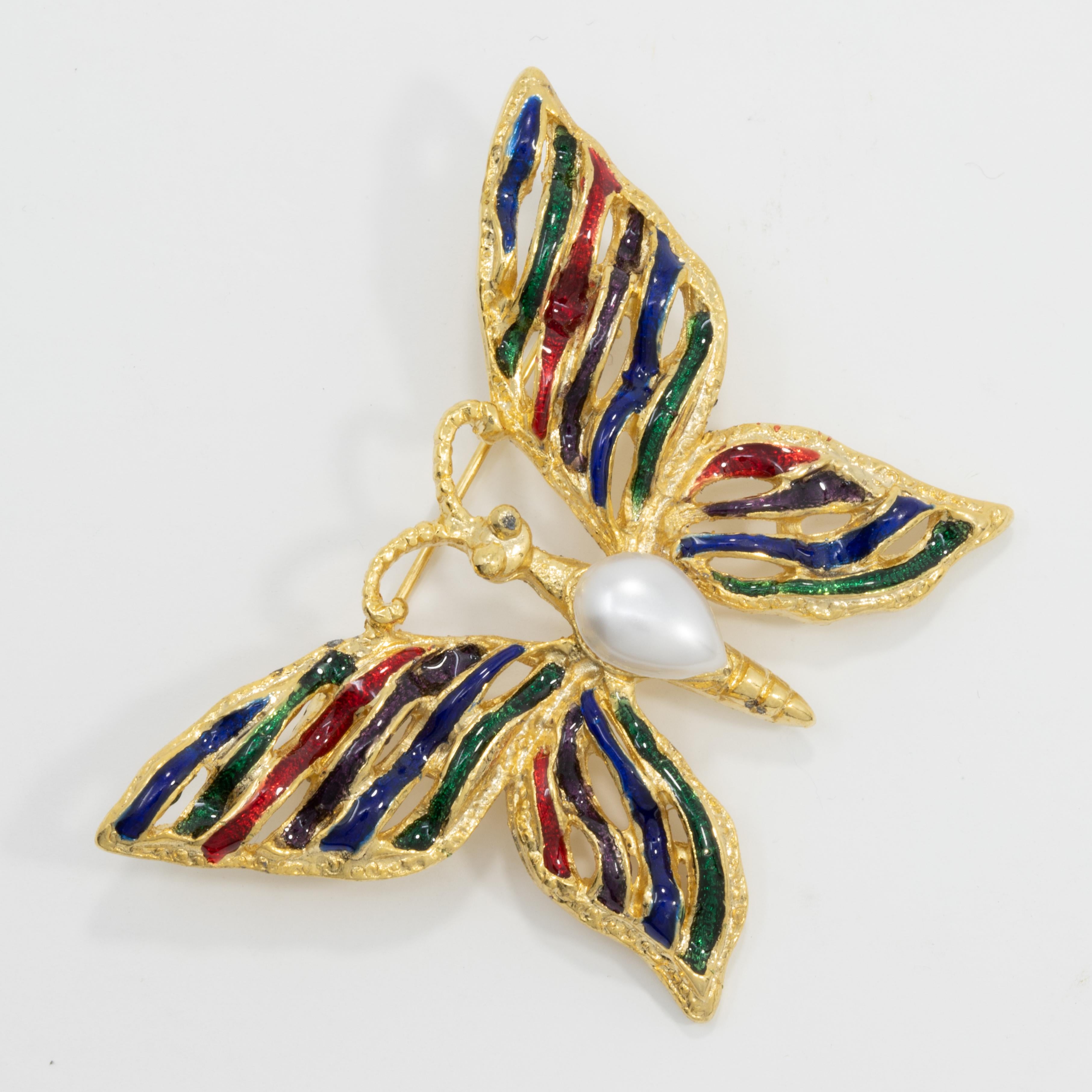 A stylish butterfly pin by Vendome, painted with red, green, and blue enamel, and accented with a single faux pearl. Gold-plated.

Excellent condition. A wonderfully preserved vintage piece that has never been worn.