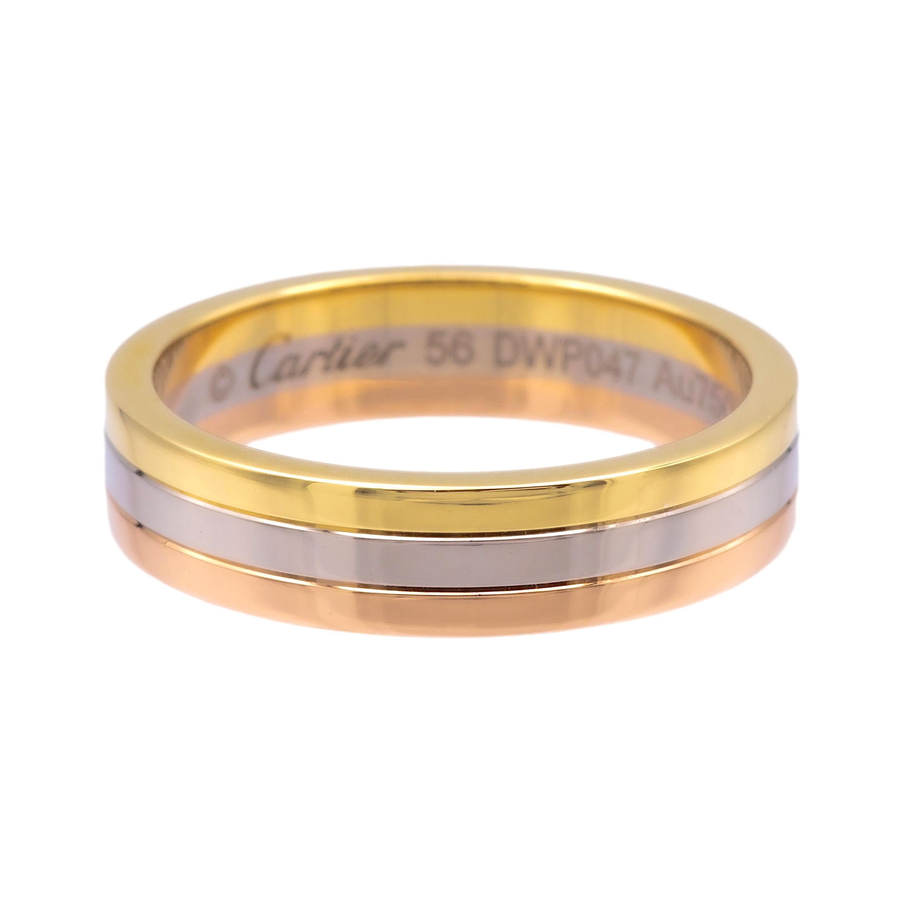 Men's Louis Cartier wedding band ring from the Vendome collection for him finely crafted in three tone 18K yellow, rose and white gold. The band has a ribbed edge finish and measures 4.8mm wide and has a finger size of 56 Europe (7.5 US). Fully