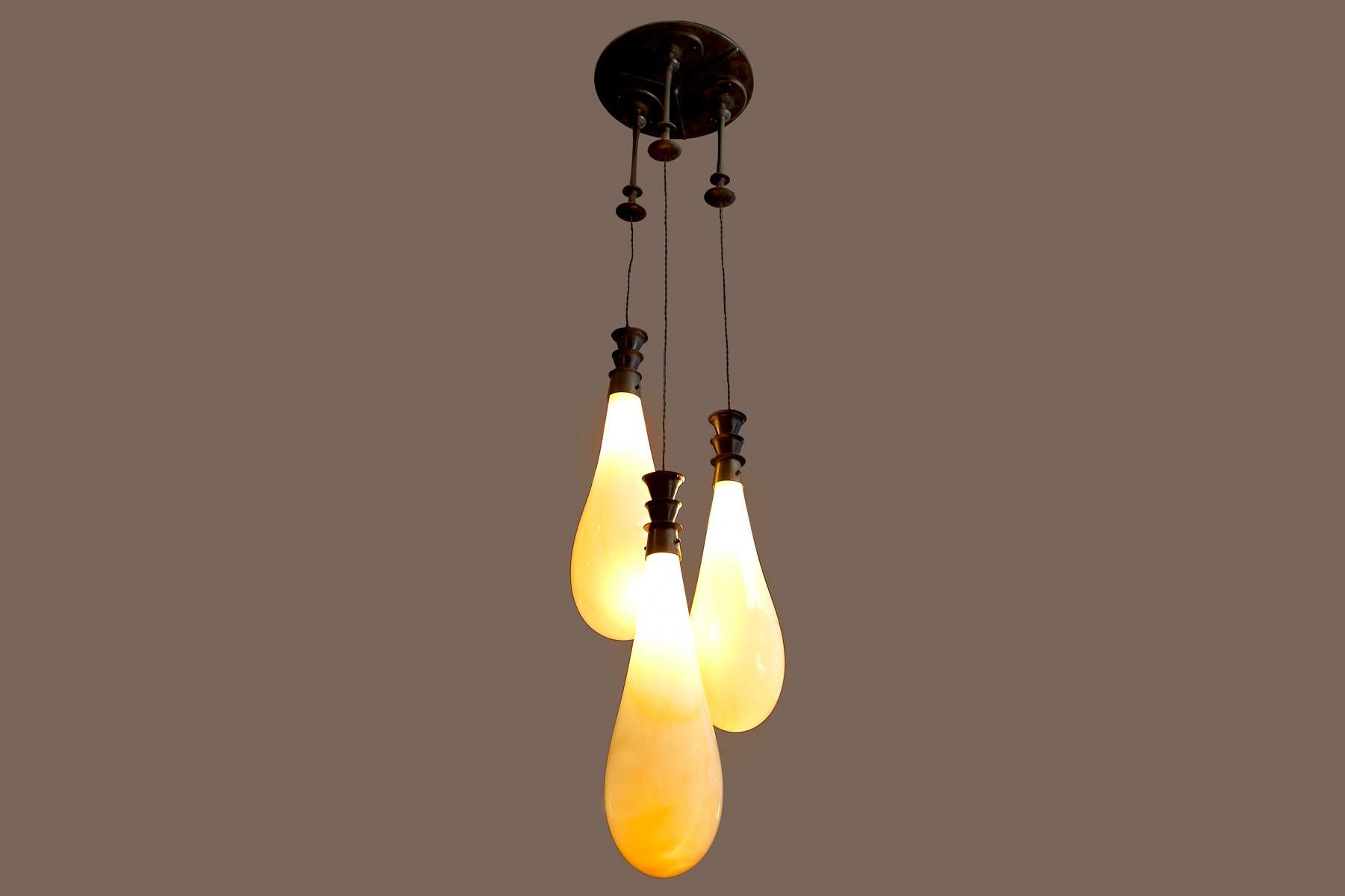 Hand Blown glass pendants, bronze patina fixtures. Nickel finish Available. Custom Dimensions Available.