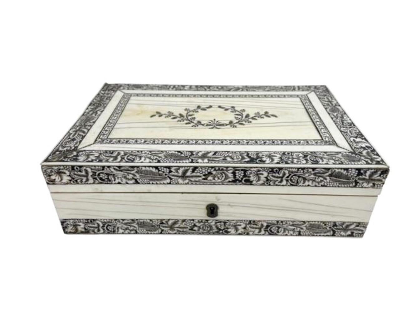 Rectangular penwork decorated veneer on sandalwood box. The top with a double border centering a floral cartouche, the four sides with wide leafy borders to top and bottom. Fitted with a lock (no key) and silvered brass stop-hinges.