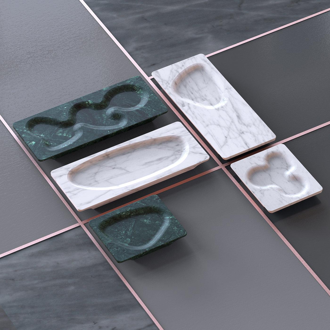 In a single piece of Verde Imperial marble, the Venerli Appetizer Tray is an original way to frame your latest culinary creations. Featuring a unique carving with fluid lines, the tray helps prevent spillage while providing a unique piece of eye