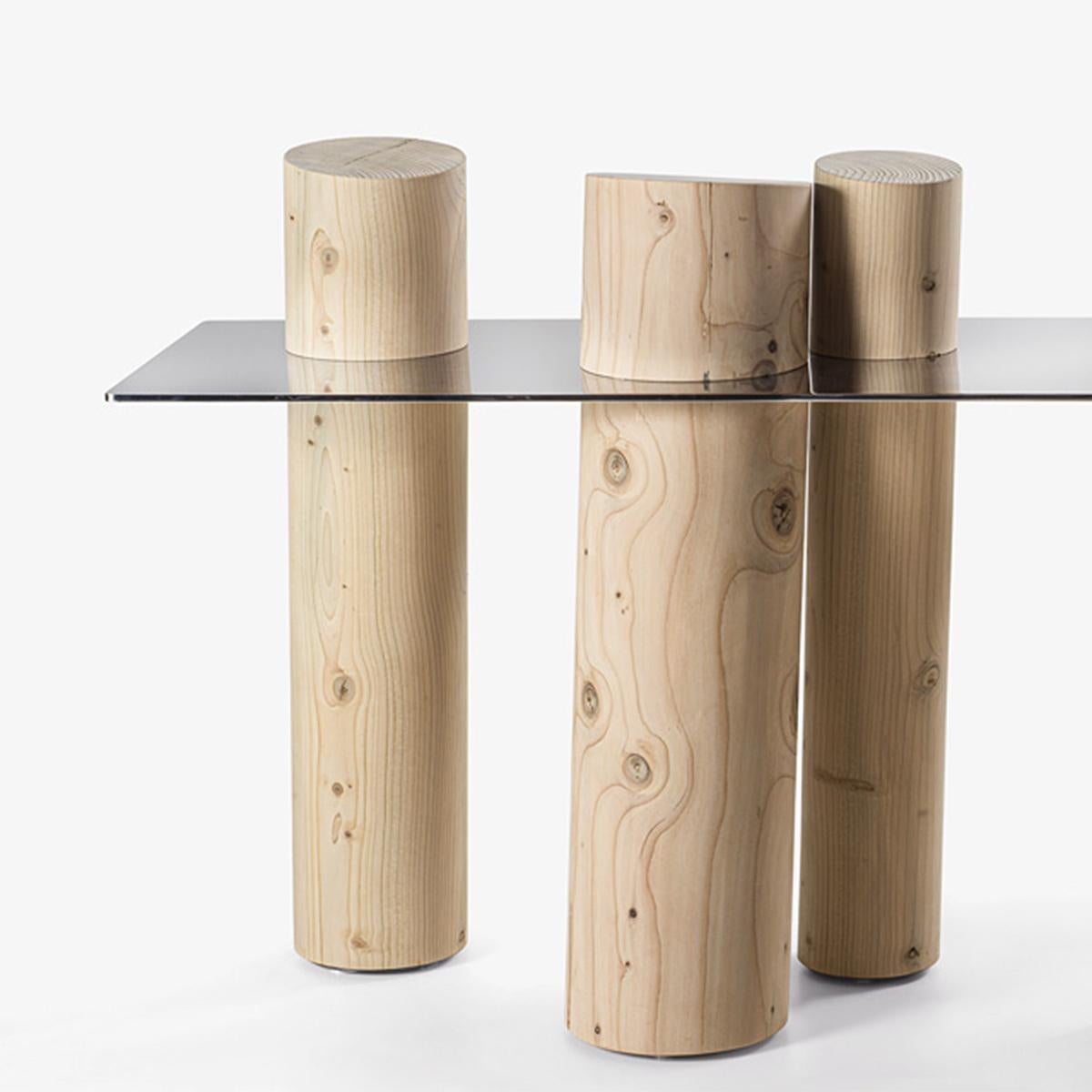 Table console Venesia Cedar avec plateau en verre smocké 8mm 
La base est constituée de 5 troncs de 180 cm de largeur en 
bois de cèdre massif.
Mesures : L180 x D50 x H69 à 91cm, 5 coffres, prix : 11900,00€.
Également disponible sur demande avec un