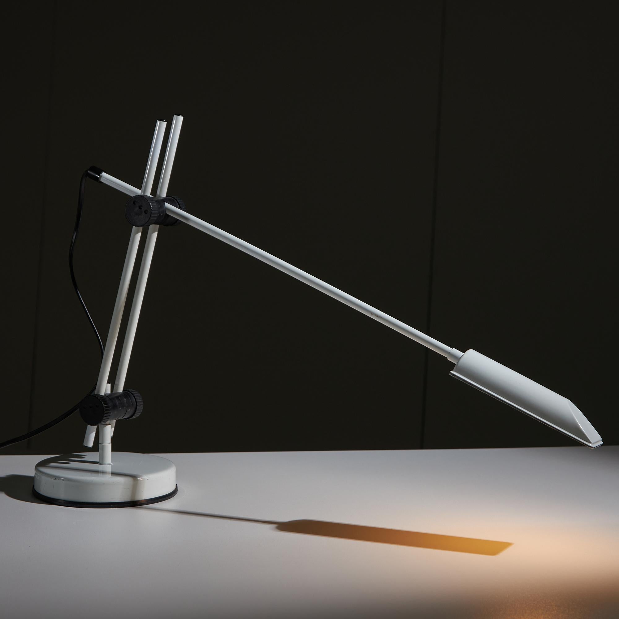 White metal desk lamp with adjustable stem and plastic black parts. This vintage item is of modern functionality and complements any interior style. It has no defects, but it may show slight traces of use.
