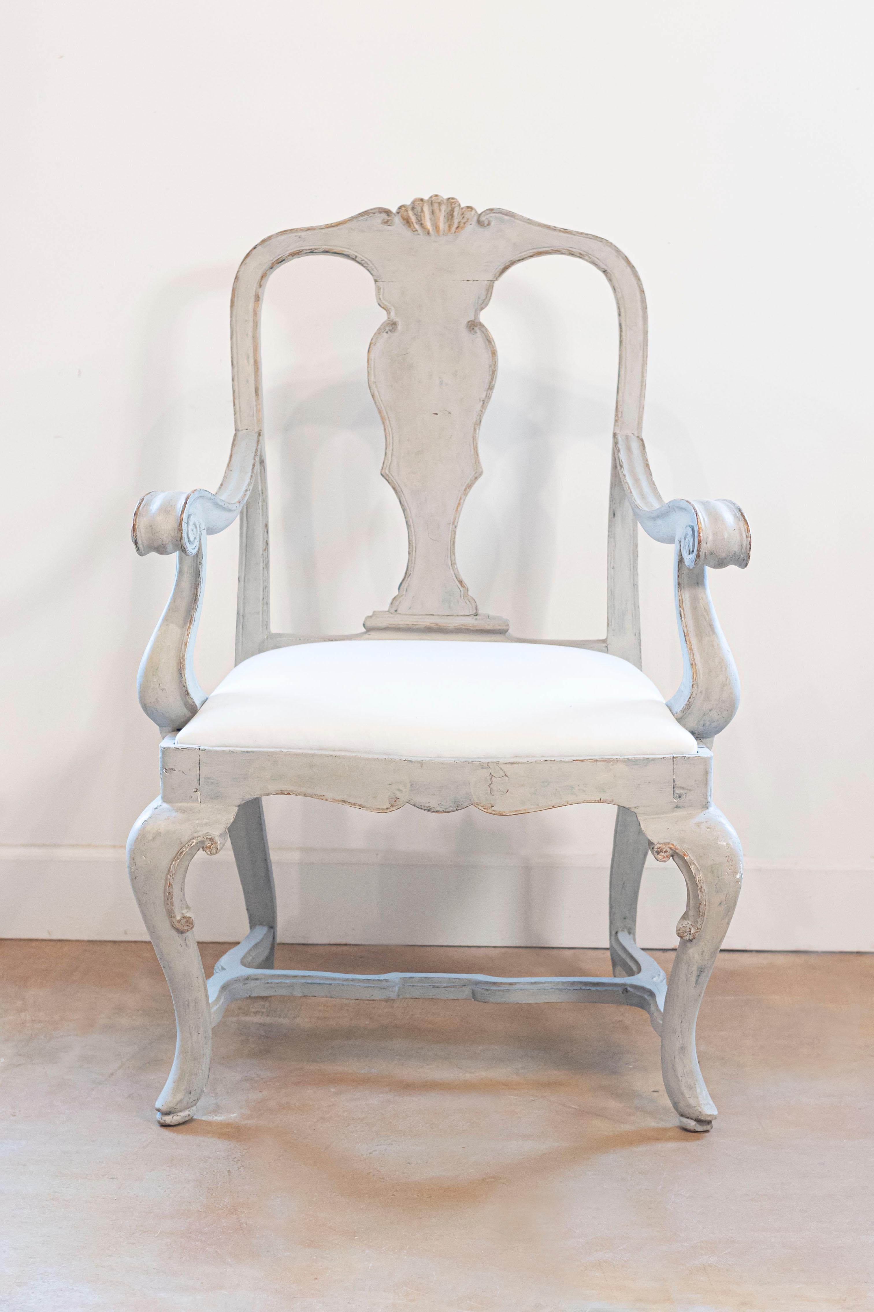 An Italian painted wood Rococo style armchair from the early 19th century, with carved splat, scrolling arms, cabriole legs and cross stretcher. Born in Venice during the early years of the 19th century, this exquisite painted armchair features a