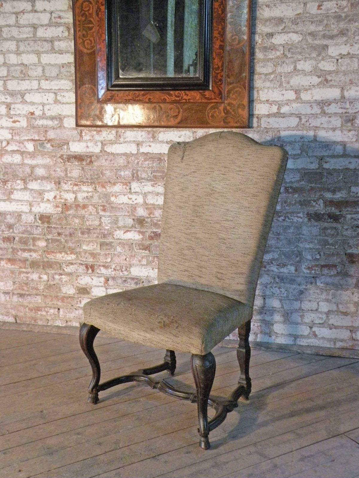 Of impressive large size and unusual design, the front legs of cabriole form ending in hoof-feet, connected to the shaped back-legs by wavy H-stretchers.
Clean-up and wax-polish included. The chair needs to be re-upholstered.