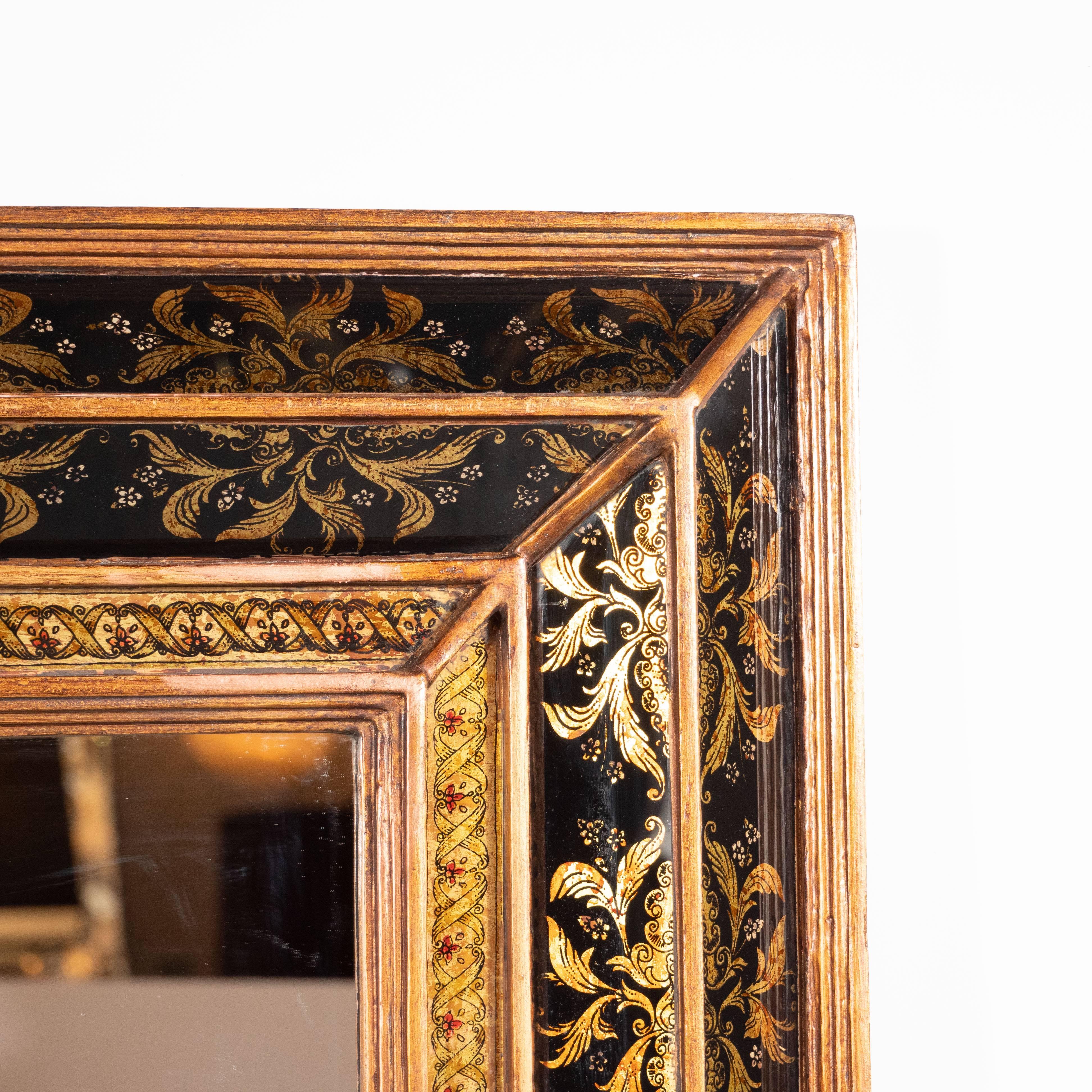 This refined mirror was realized in Venice, Italy, circa 1945. It features a segmented giltwood frame with a raised pyramidal border in relief with reverse églomisé gold foliate and floral detailing on both sides. The interior border framing the