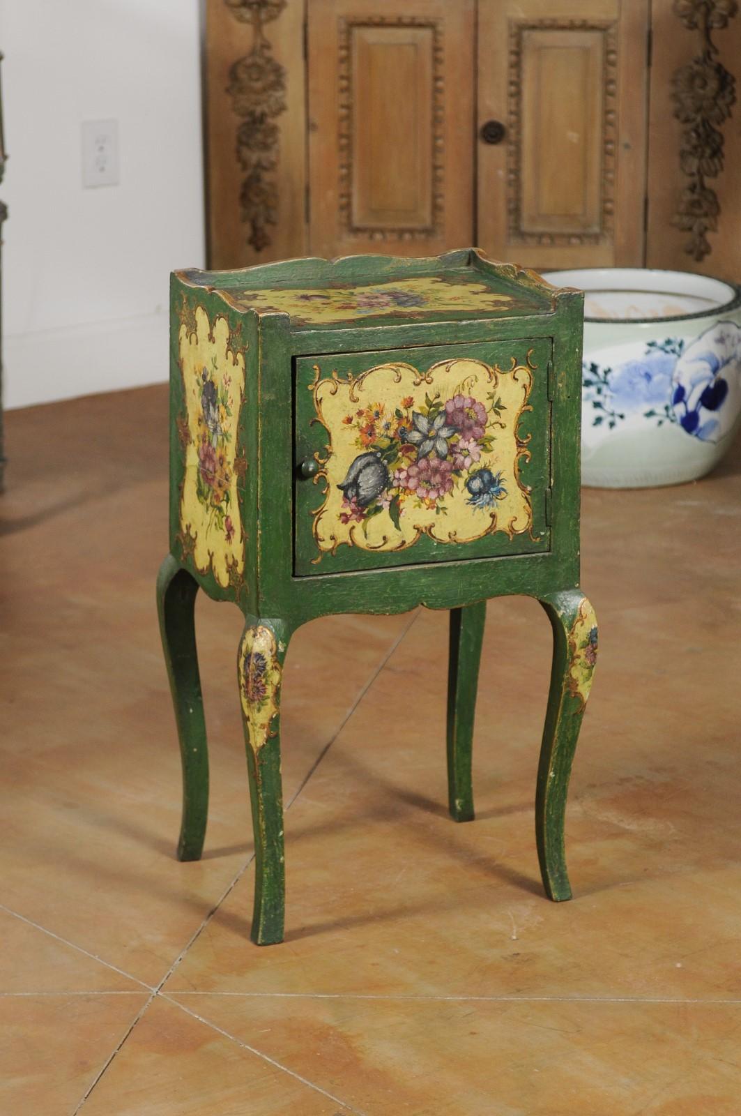 A Venetian Rococo style wood bedside table from the 19th century, with painted floral décor, single door and cabriole legs. Born in the Serenissima during the 19th century, this small bedside table features a rectangular top surrounded by a