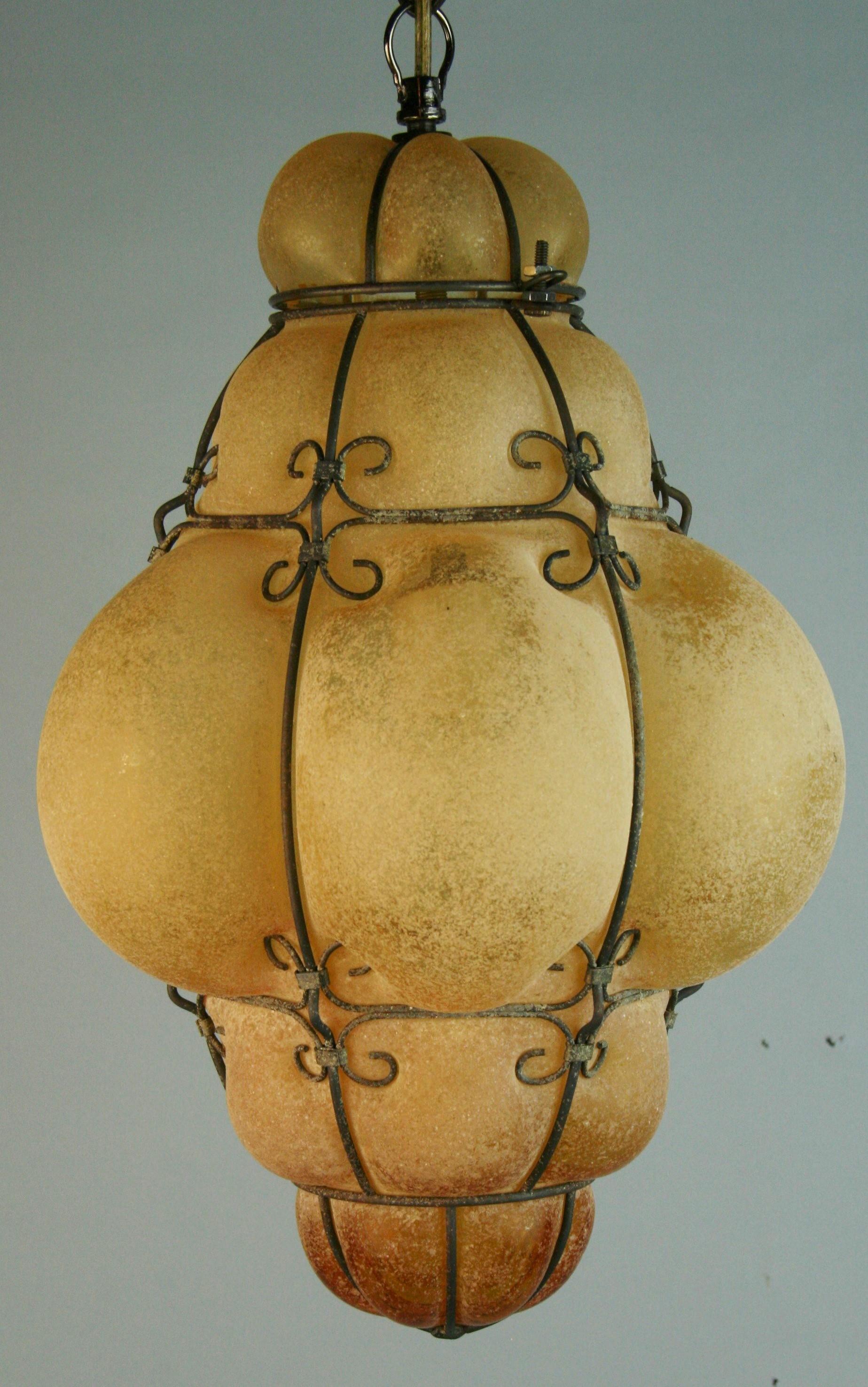 1298 Venetian amber glass pendant in wire cage with sand imbedded finish
2 available priced individually