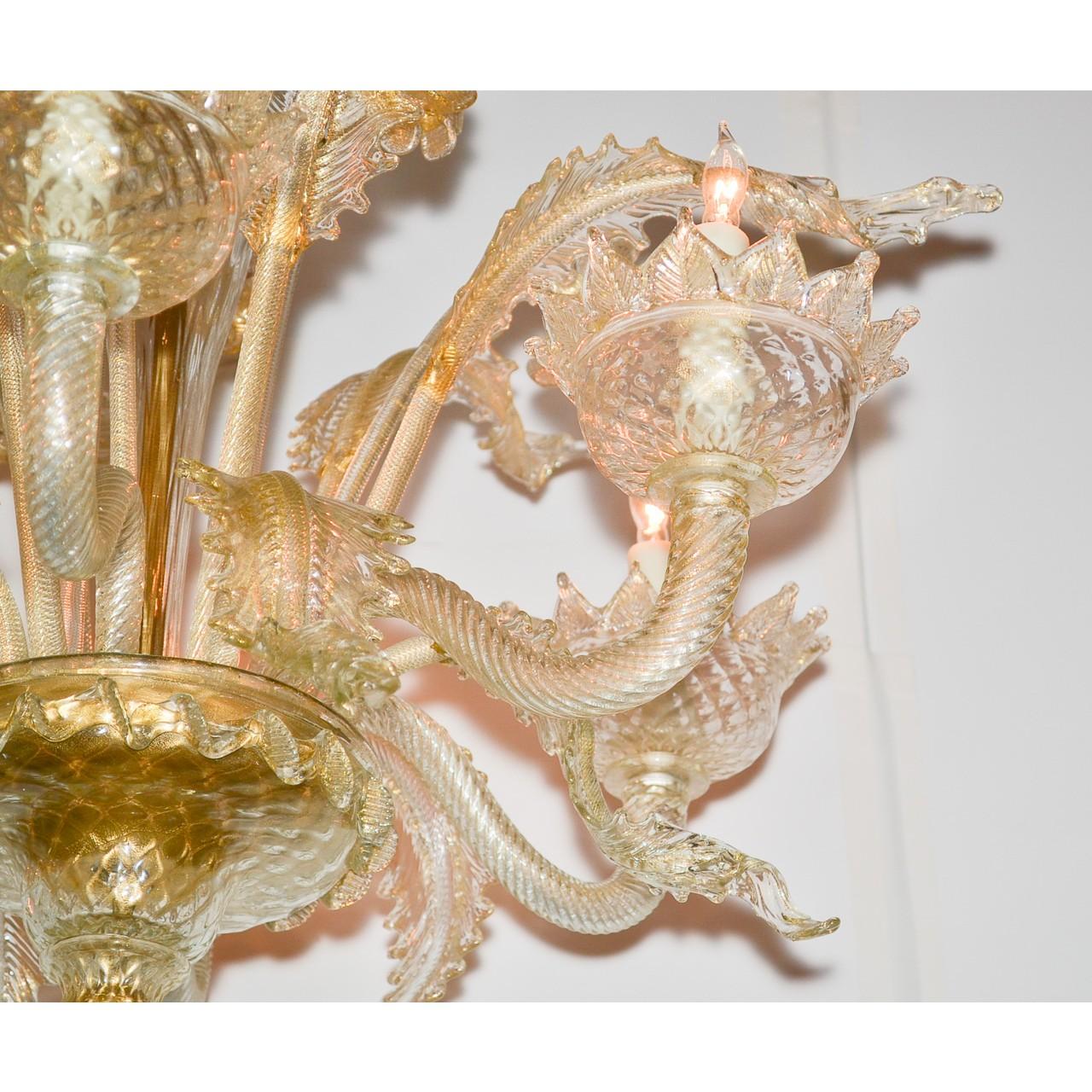 Fanciful and fine Venetian chandelier in hues of amber to clear glass. The bowl-shaped canopy with a flower petal border atop long shaped and ruffled leaf sprays accented large flower heads. Mounted with gracefully contoured arms having cup-shaped