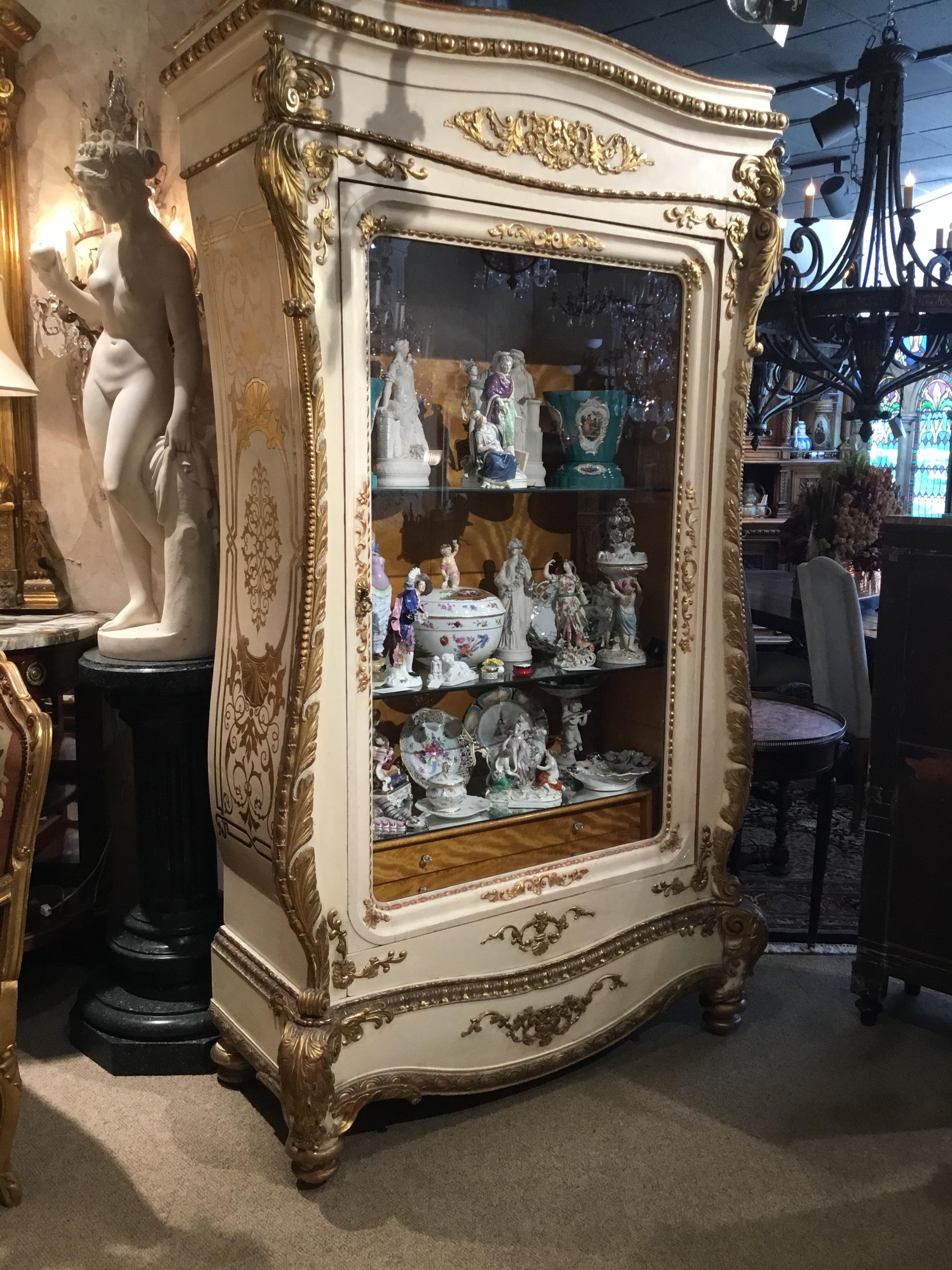 Amazing and beautiful large display cabinet, with hand carving and Fine gilding.
Curved shape to the bonnet of this piece and gracefully carved sides make this
Piece special. Glass shelves are movable to vary the height of the displays. A