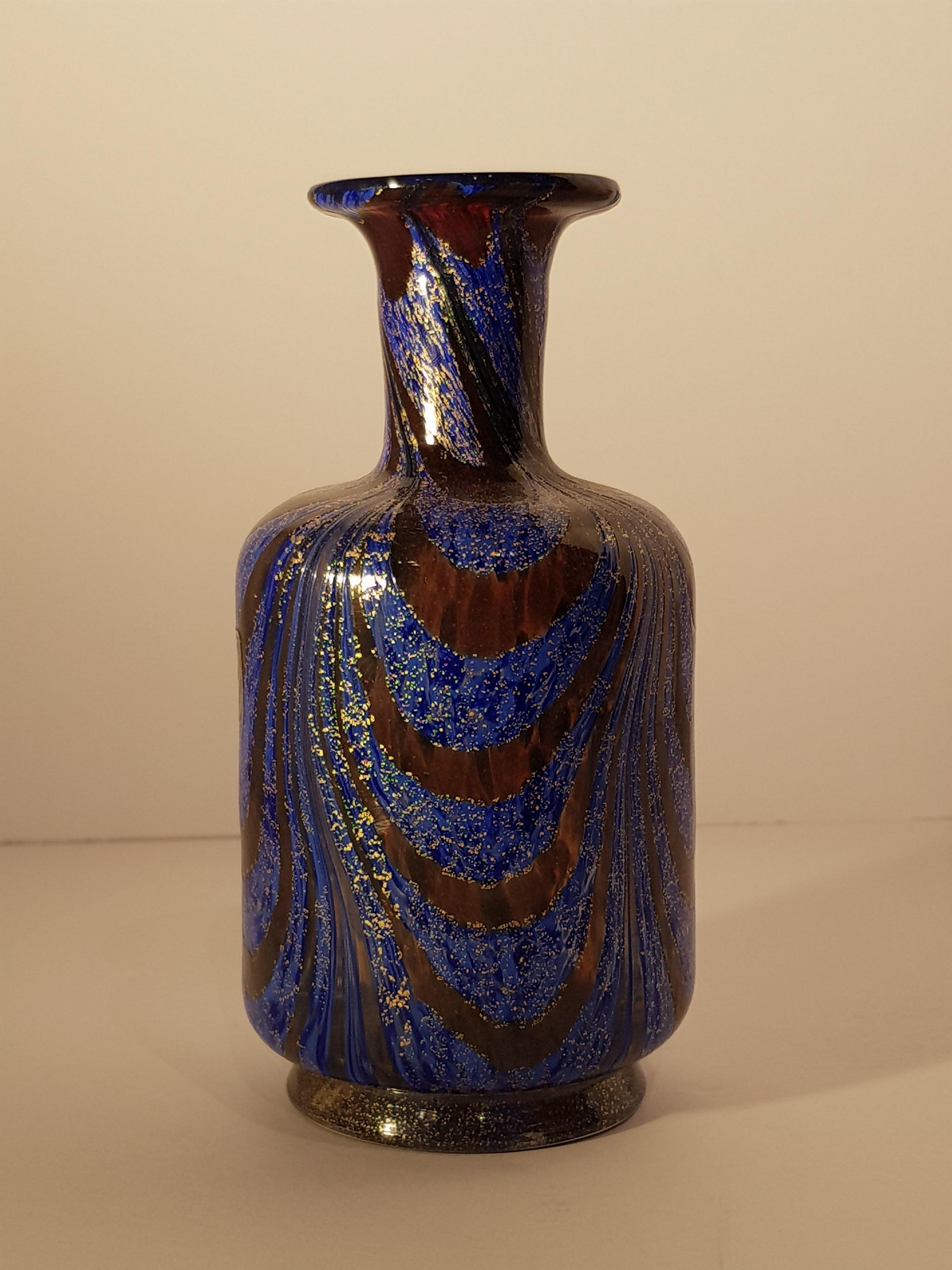 Rare and unique Venetian art glass vase or bottle with a beautiful pulled feather fenicio design. Delicate gold gilt aventurine flecks cover the surface of this art glass vase complementing the blue and tortoise colored glass body. A clear glass