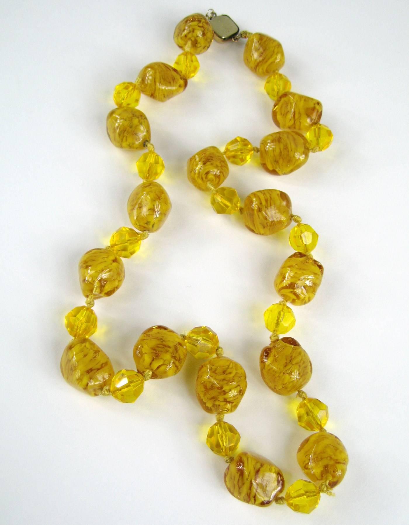 A Stunning Venetian Gold Foiled Glass Bead Necklace. This necklace will be noticed, it has Huge Venetian Glass beads, all hand knotted. Large beads make up this wonderful necklace in two different sizes, the smaller beads are faceted. Clasp marked