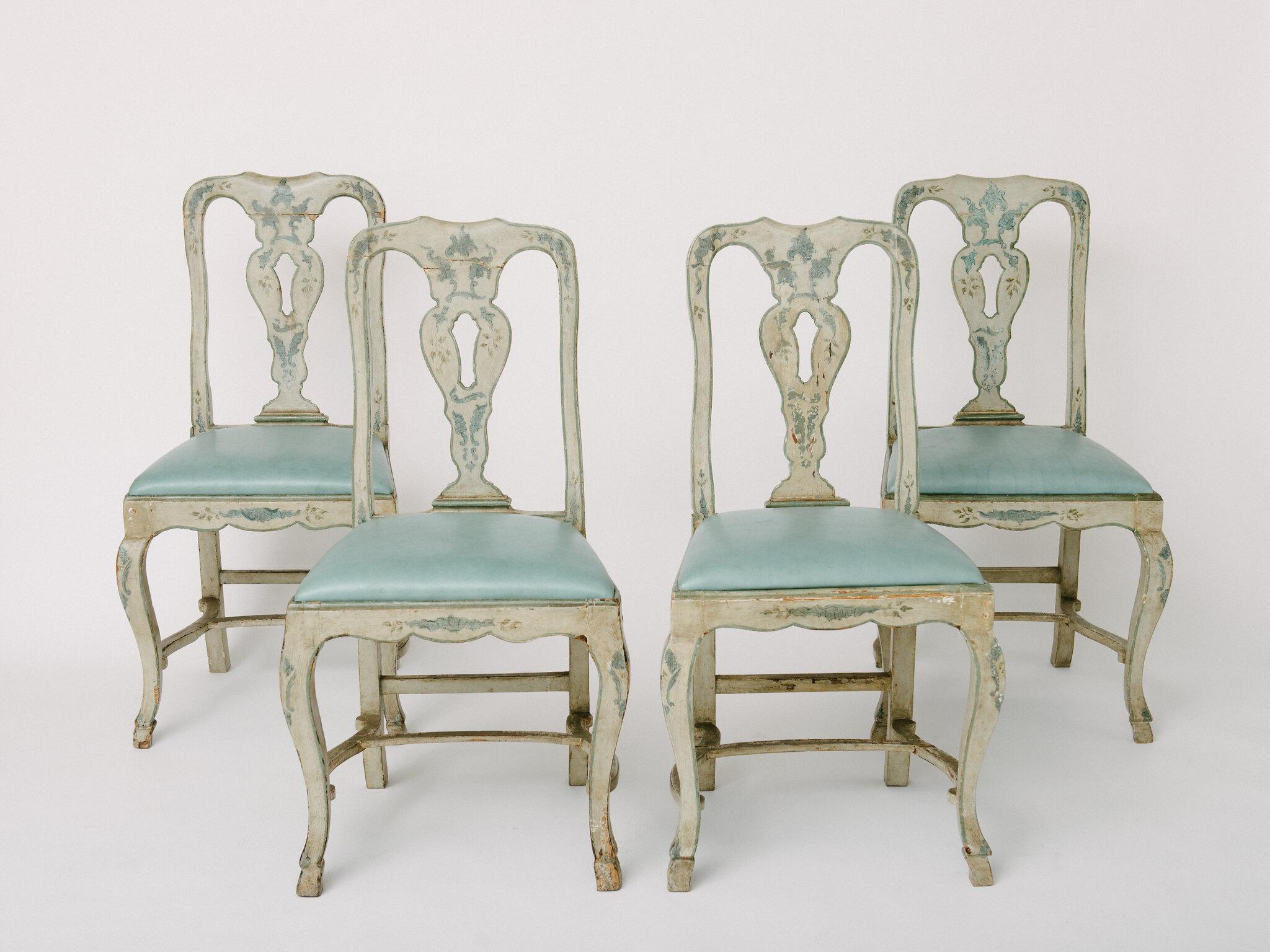 18th century blue-gray painted Venetian side chairs with leather seats. Chairs have a Heraldic style cross maker's mark engraved on backs of chairs. Features hand carved stretchers and pied-de-biche hooves, seat covered in a sky blue leather. Uneven