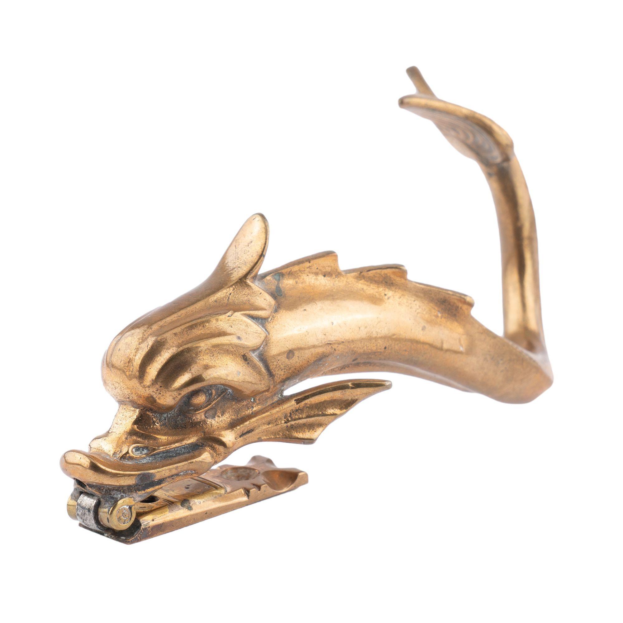 Venetian gondola fitting of a cast brass dolphin, modified with a hinge for use as a door knocker.
Venice, Italy, 1875-1900.