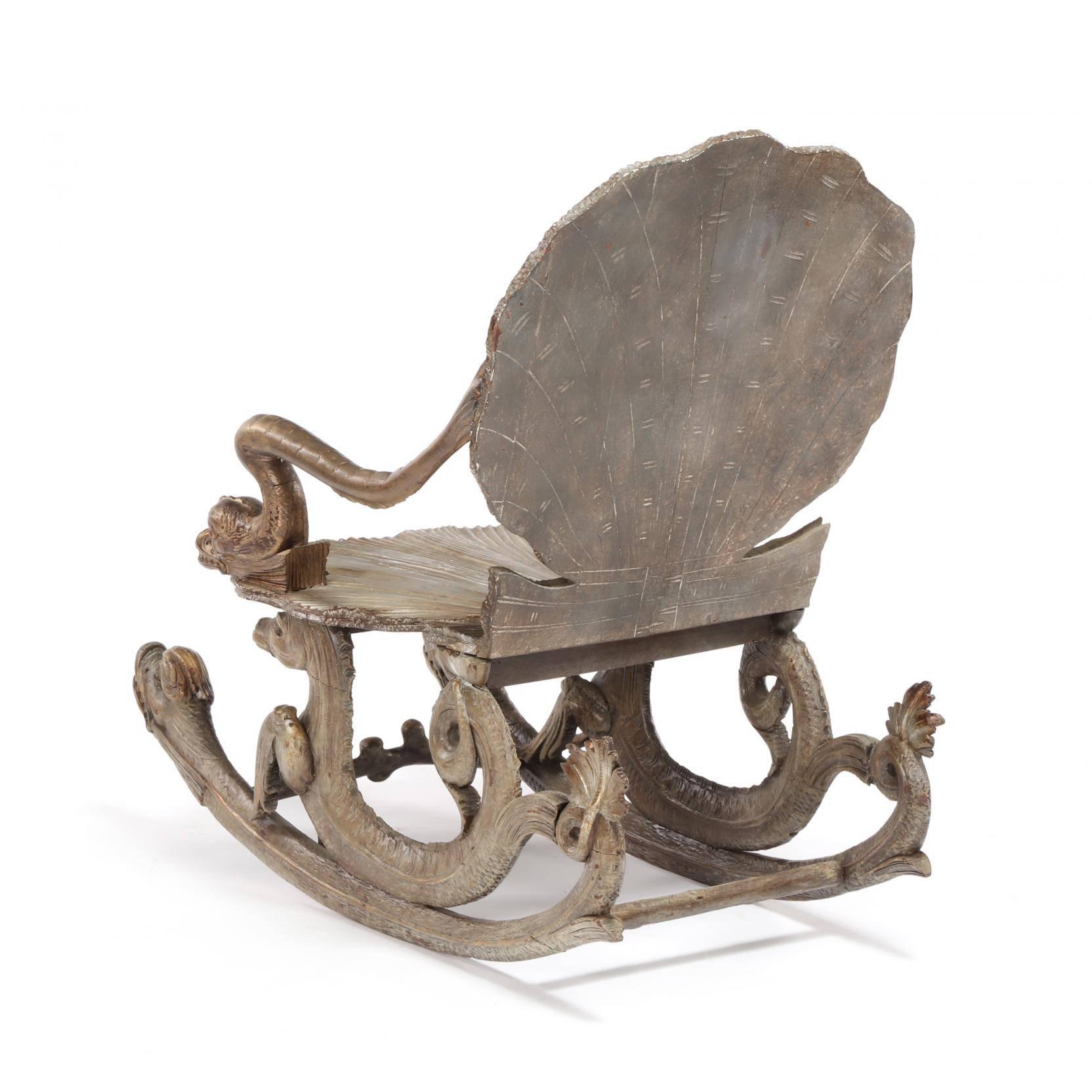 Attributed to Pauly & Cie, 19th century, shell carved back and seat with carved dolphin arm supports and rocker heads, seahorse carved seat supports, silvered and gilt finish.