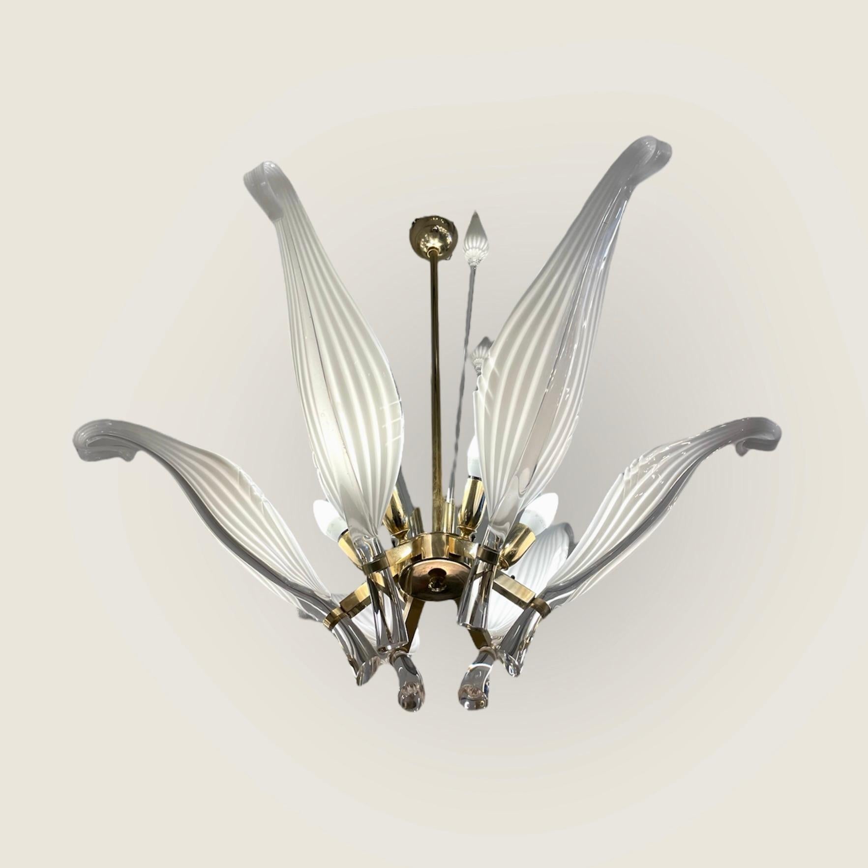 Spectacular large chandelier made of blown Murano glass and gold-plated brass. Drawn by Italian designer Franco Luce and made in Murano Island, Italy by Seguso in the 1960’s.
-
6 leaves, 3 flower bulbs, and 6 light sources.
-
Designed by: Floco