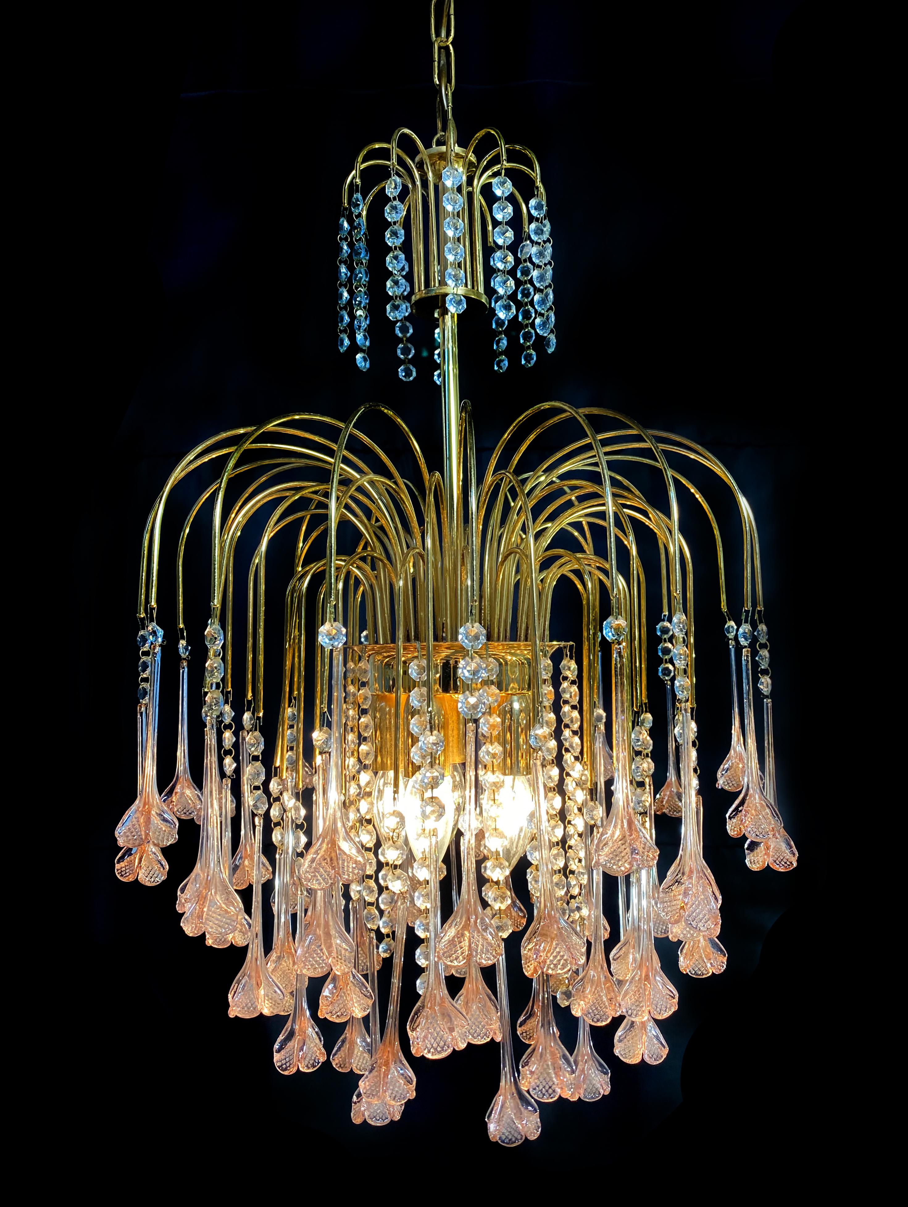 Elegant Venetian chandelier. Dozens of pink flowers hang from the golden canopy. Five small lights.
  