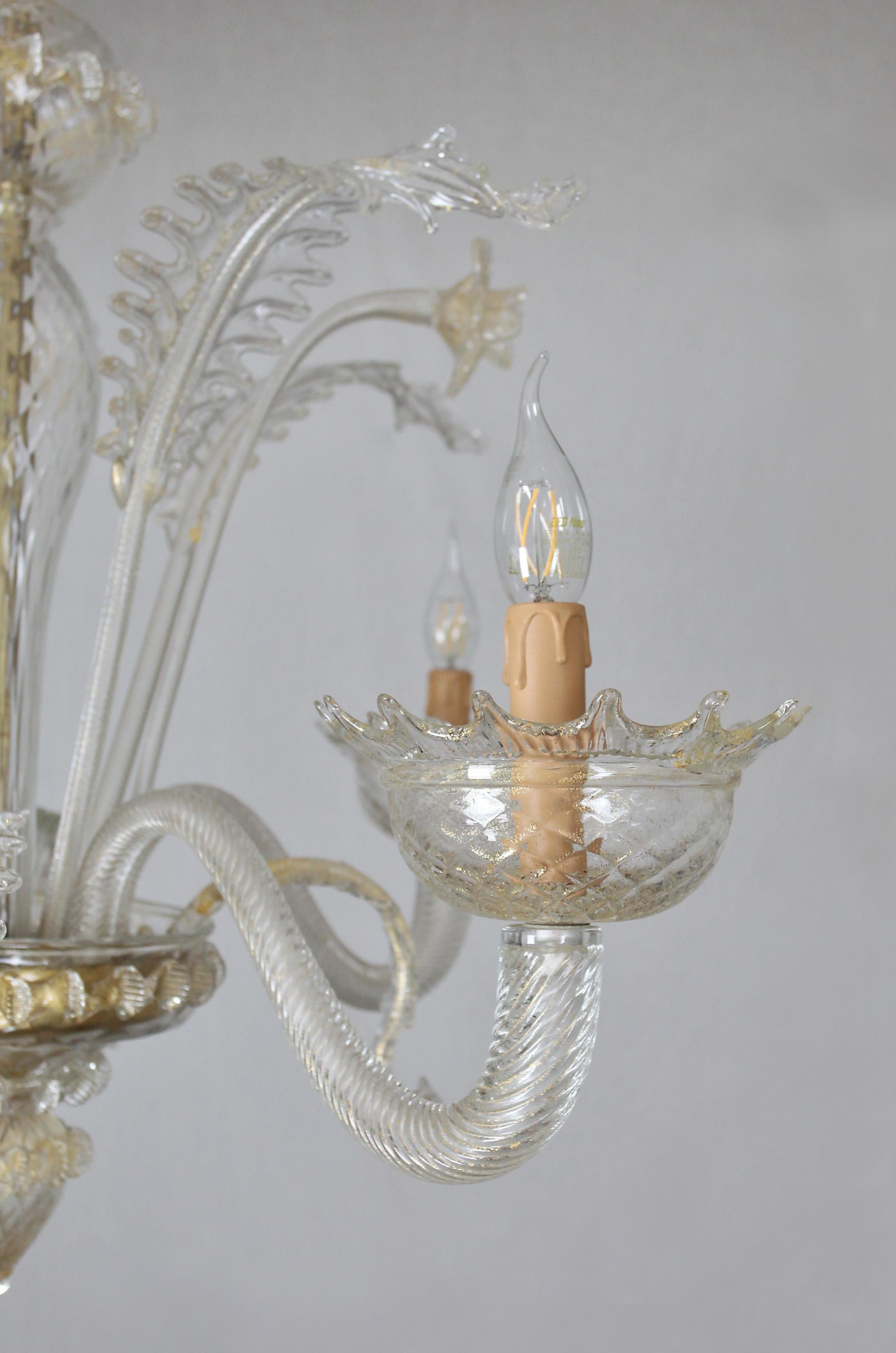 Beautiful Venetian chandelier with completely new wiring, sockets and covers. The chandelier is complete and fully functional. Blown and chipped glass decorated with fine gold dust. Provenance: Italy - Murano. Date: around 1960.

Dimensions: height