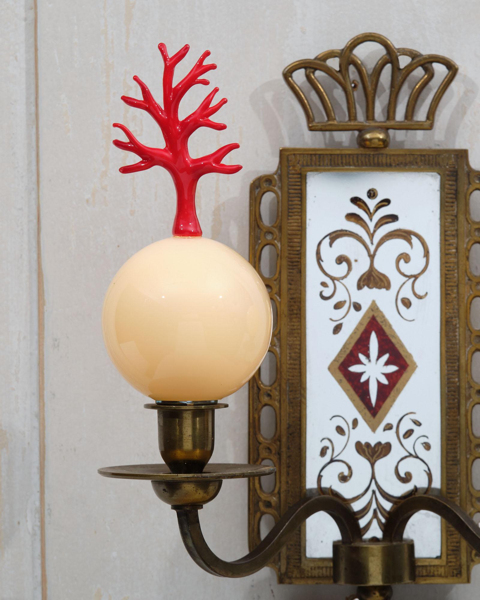 Italian pair of sconces in brass and eglomised mirror. Featuring two Murano glass spheres with glass coral finials.