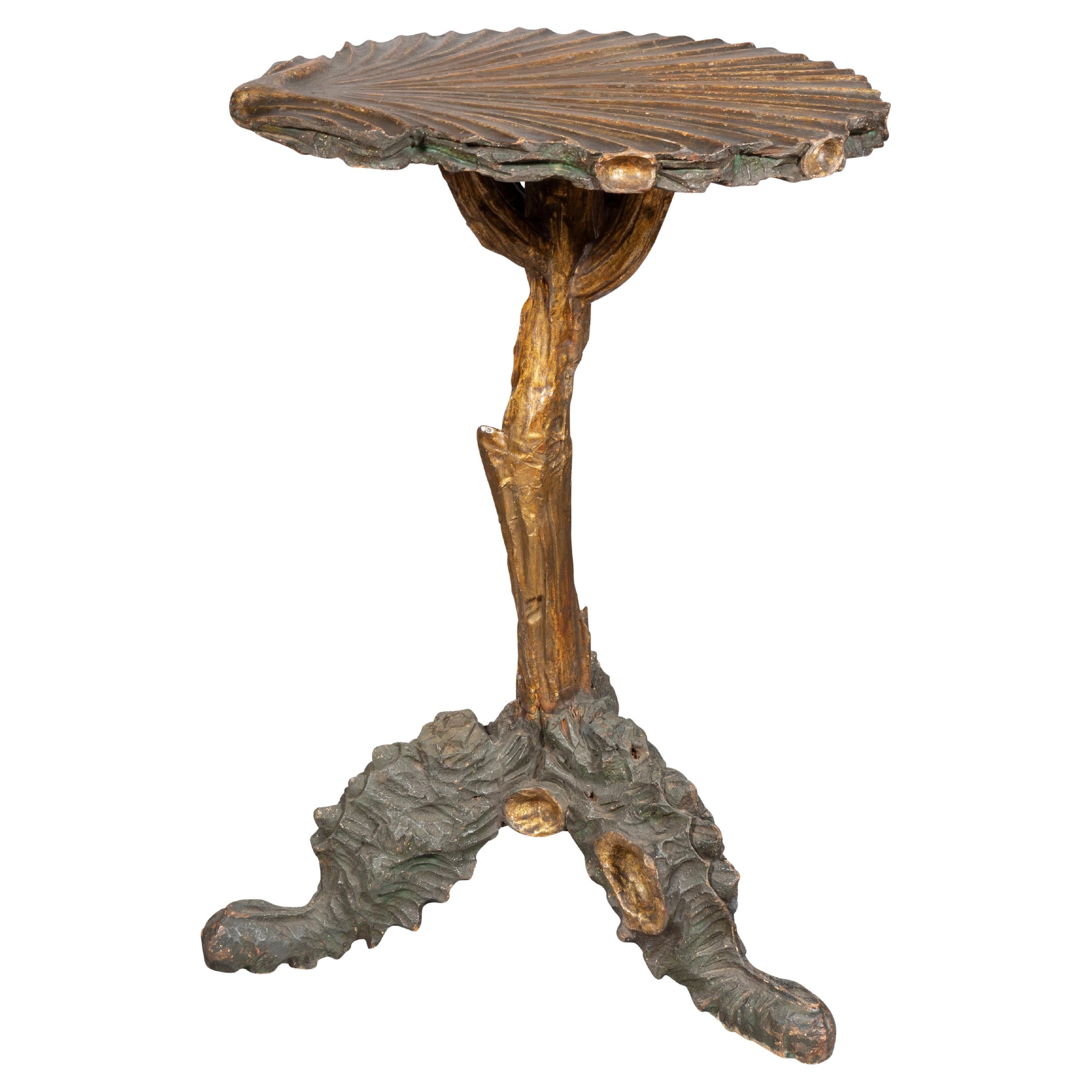 With a scallop shell top and naturalistic tree limb support with coral and oyster shell three part legs.