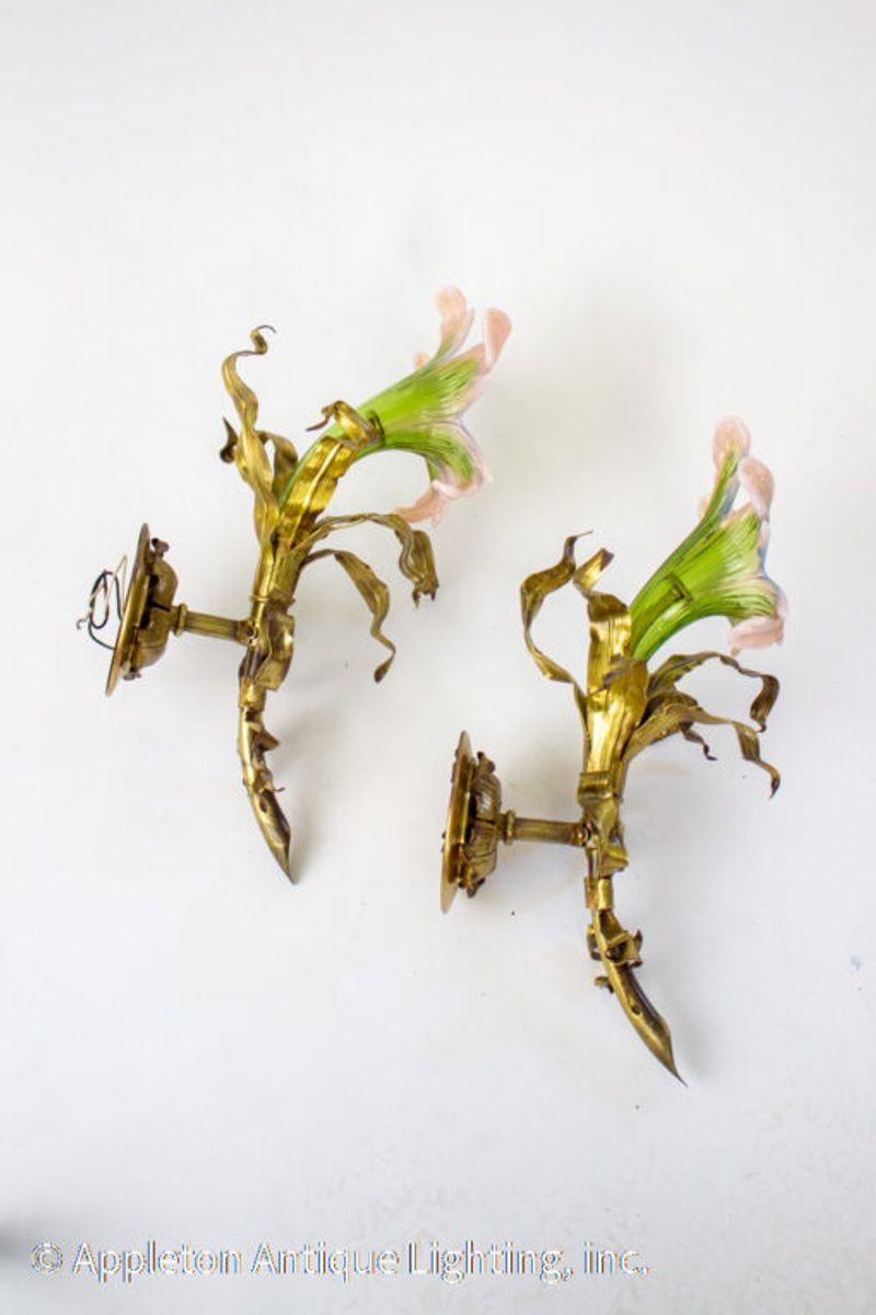 Early 20th Century Venetian glass flower sconces. The petals are blown glass in green with pink tips. The the rest of the sconces are in the shape of the flower stem with a bow tied around it. Delightful sconces.

Material: Blown Glass,Metal
Style: