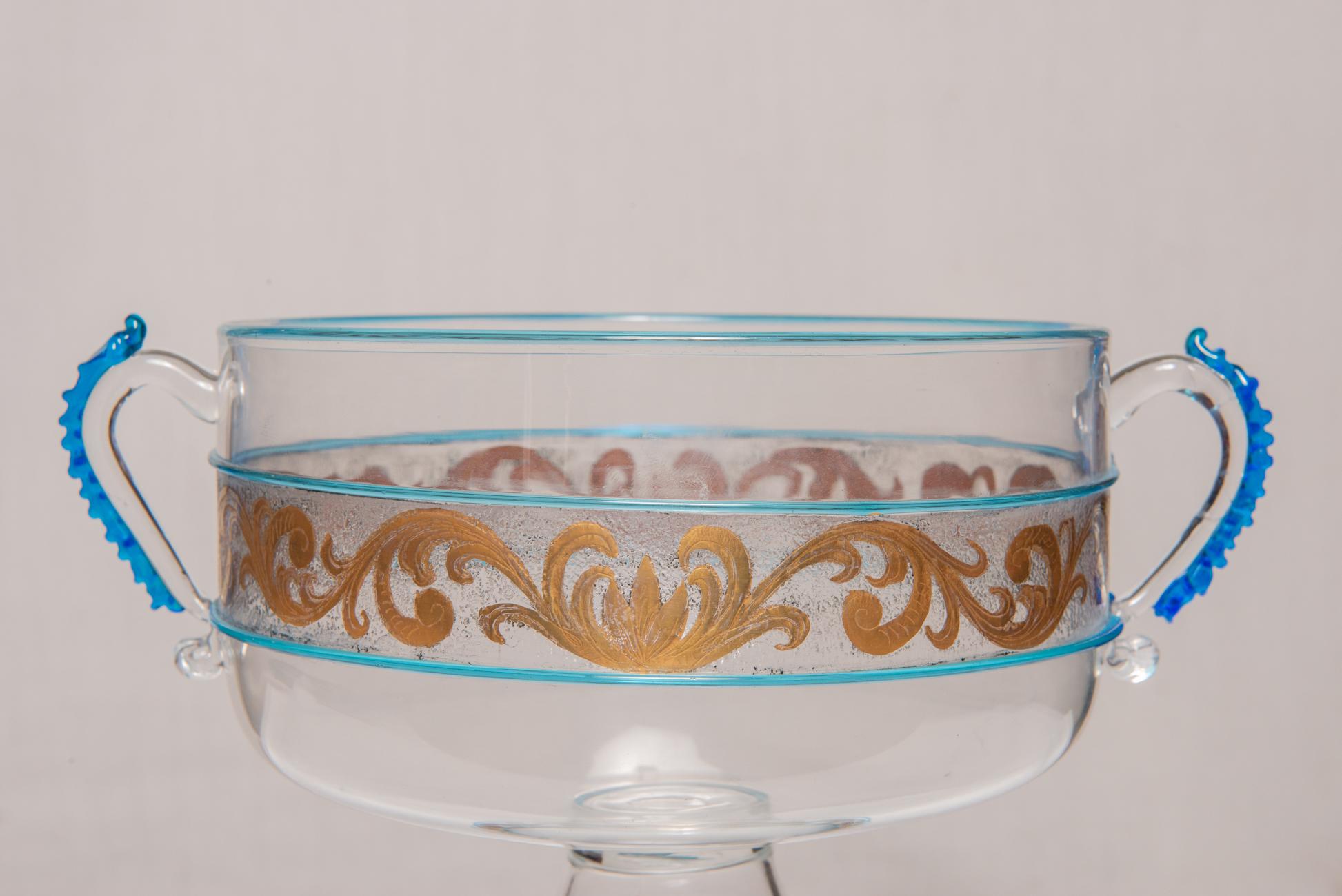 nr. 2110 - Vintage beautiful glass and gold bowl with handles by Morise : cabinet maker in Venice.
Festoons in pure gold, handles with relief details: a very elegant interesting Venetian item with a good price.