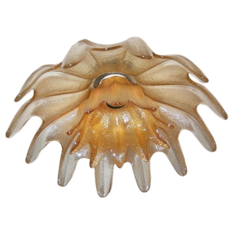 A circa 1950's flower shaped bi-level iridescent amber Murano light fixture with center light. Could be mounted flush or with a center rod.

Measurements:
Diameter
Drop 7