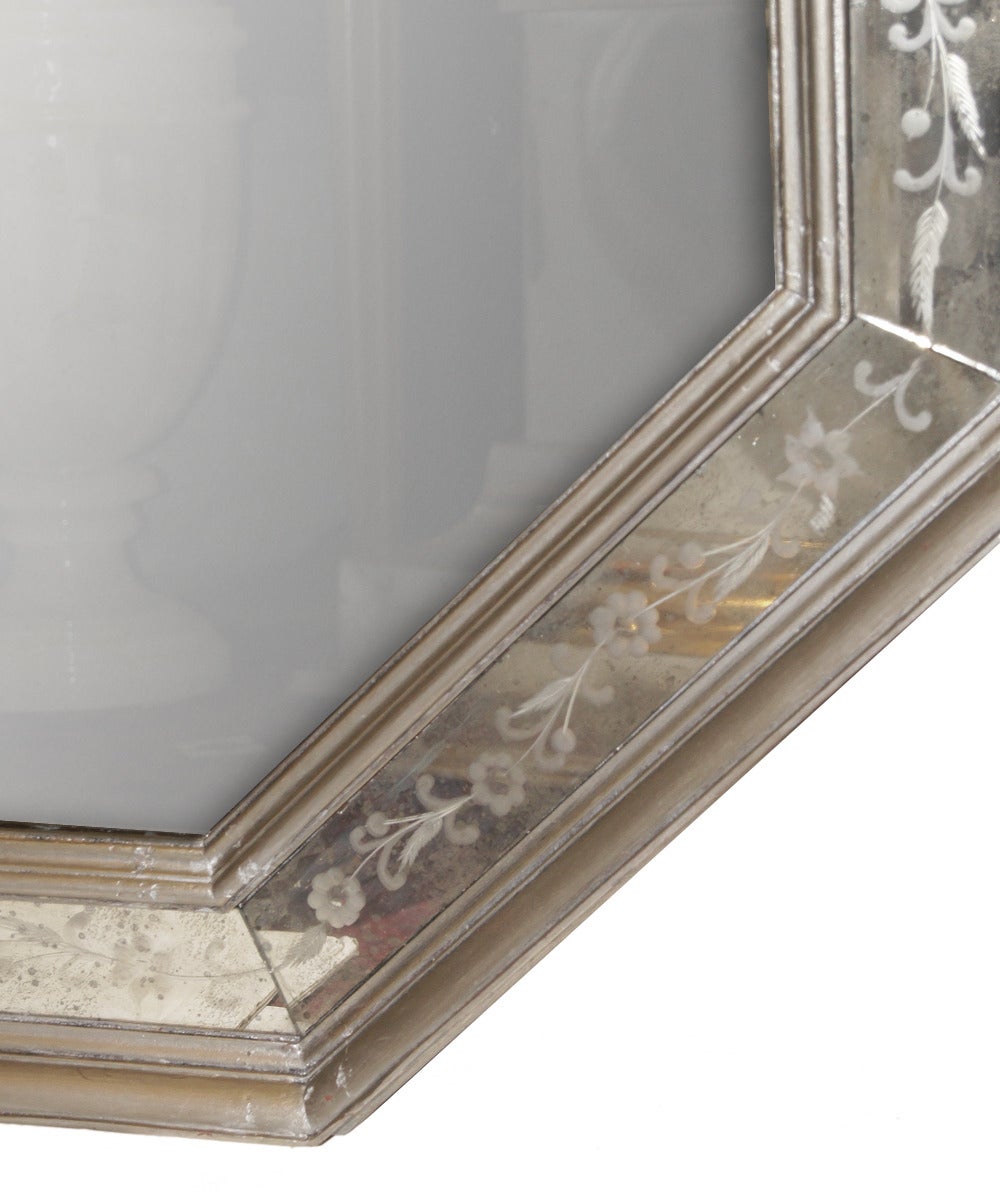 An octagonal-shaped Venetian mirrors with silver leaf frame, etched mirror details on frame in foliage and floral motifs. 

Measurements:
Height 53.5