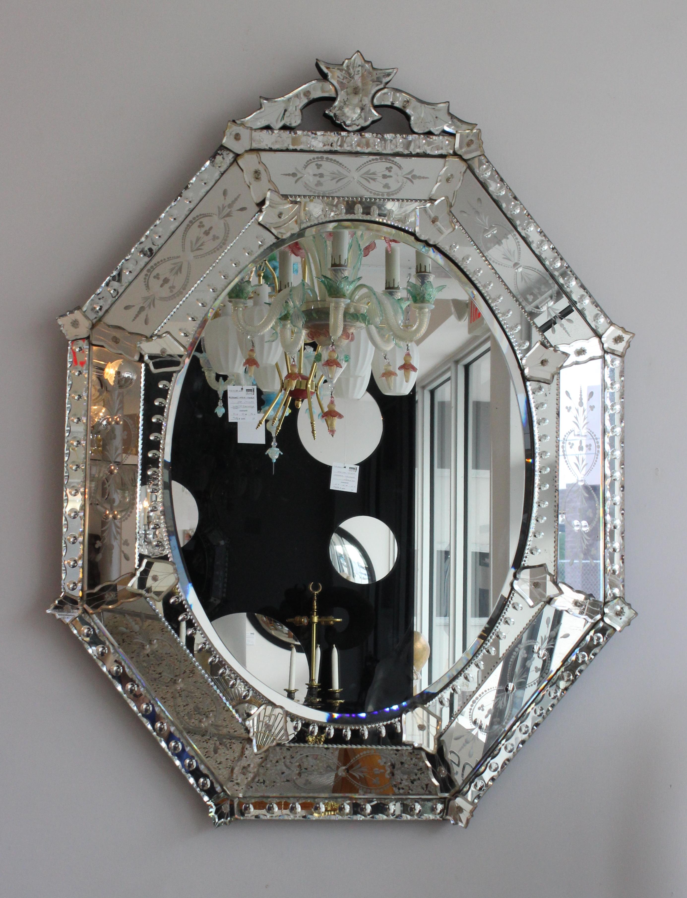 This stylish and chic Venetian mirror dates to the 1960s and was acquired from a private estate in the Sherry Netherlands of New York City.   The mirror shows some age related oxidation ,and at some point in time the back was replaced. 