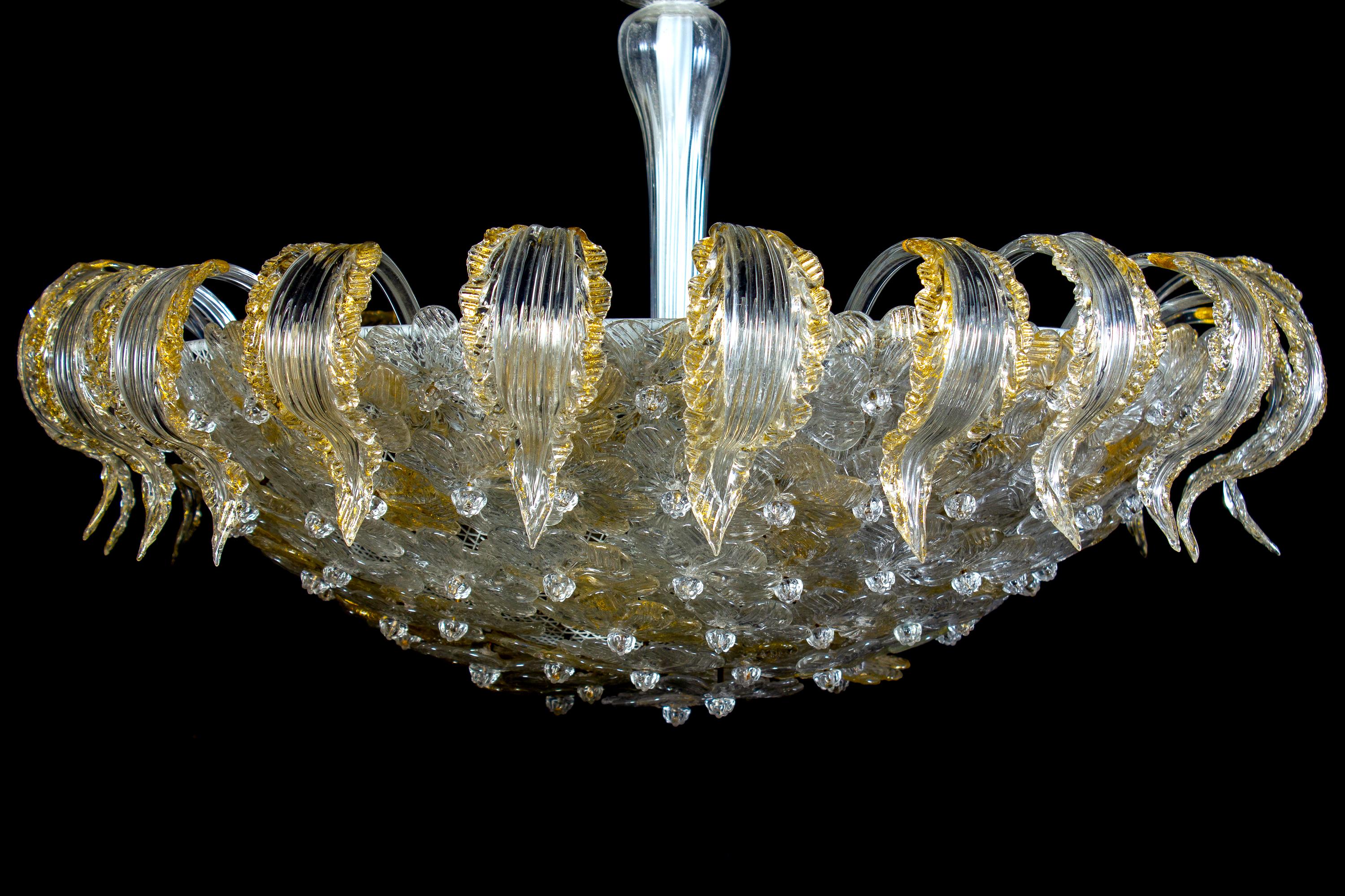 This rare and large flower basket is made of dozen gold and ice color Murano flowers glasses surrounded by a Cascade of precious hand blown leaves with gold intrusion . Three E 27 light bulbs.
