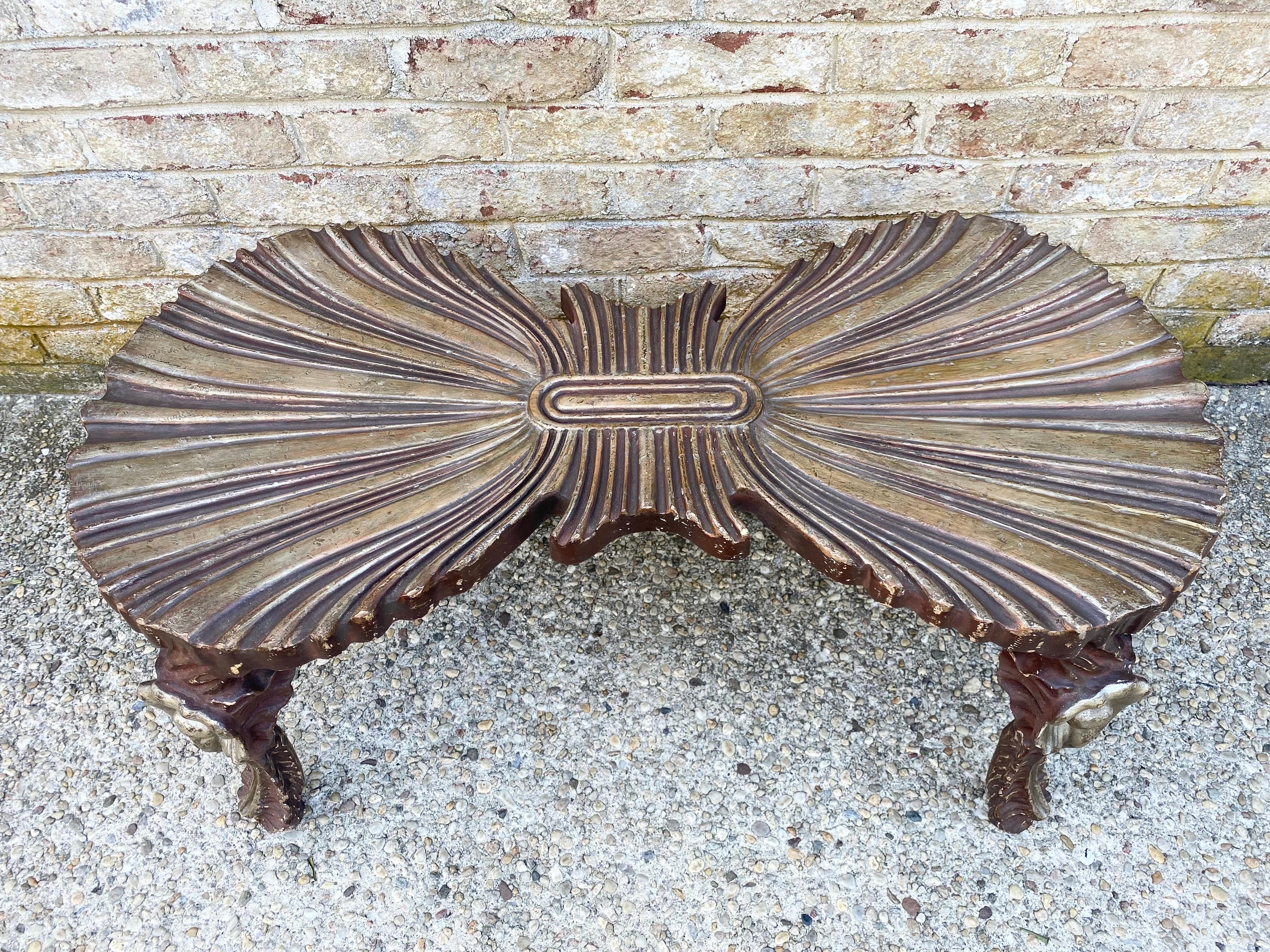 A unique and beautiful carved and gilded Venetian grotto style bench with carved shell legs and scalloped seat.