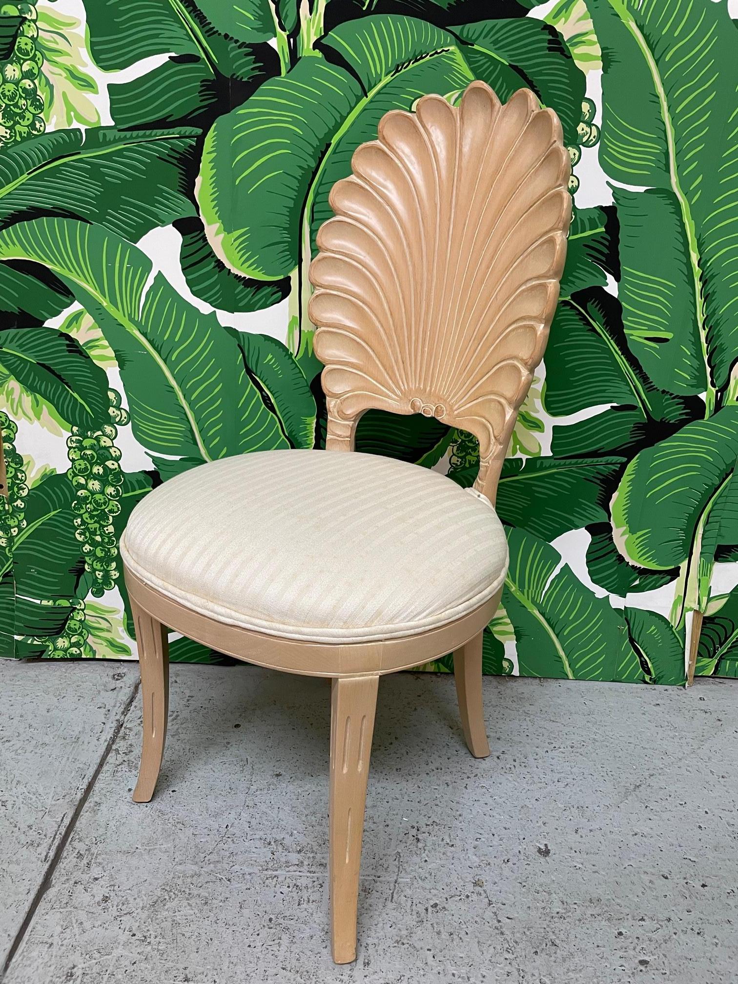 Set of six solid wood carved dining chairs in the Italian grotto style feature shell design and upholstered seats. Four side chairs and two arm chairs. Very good condition, with some staining on upholstery. Seat height is 19