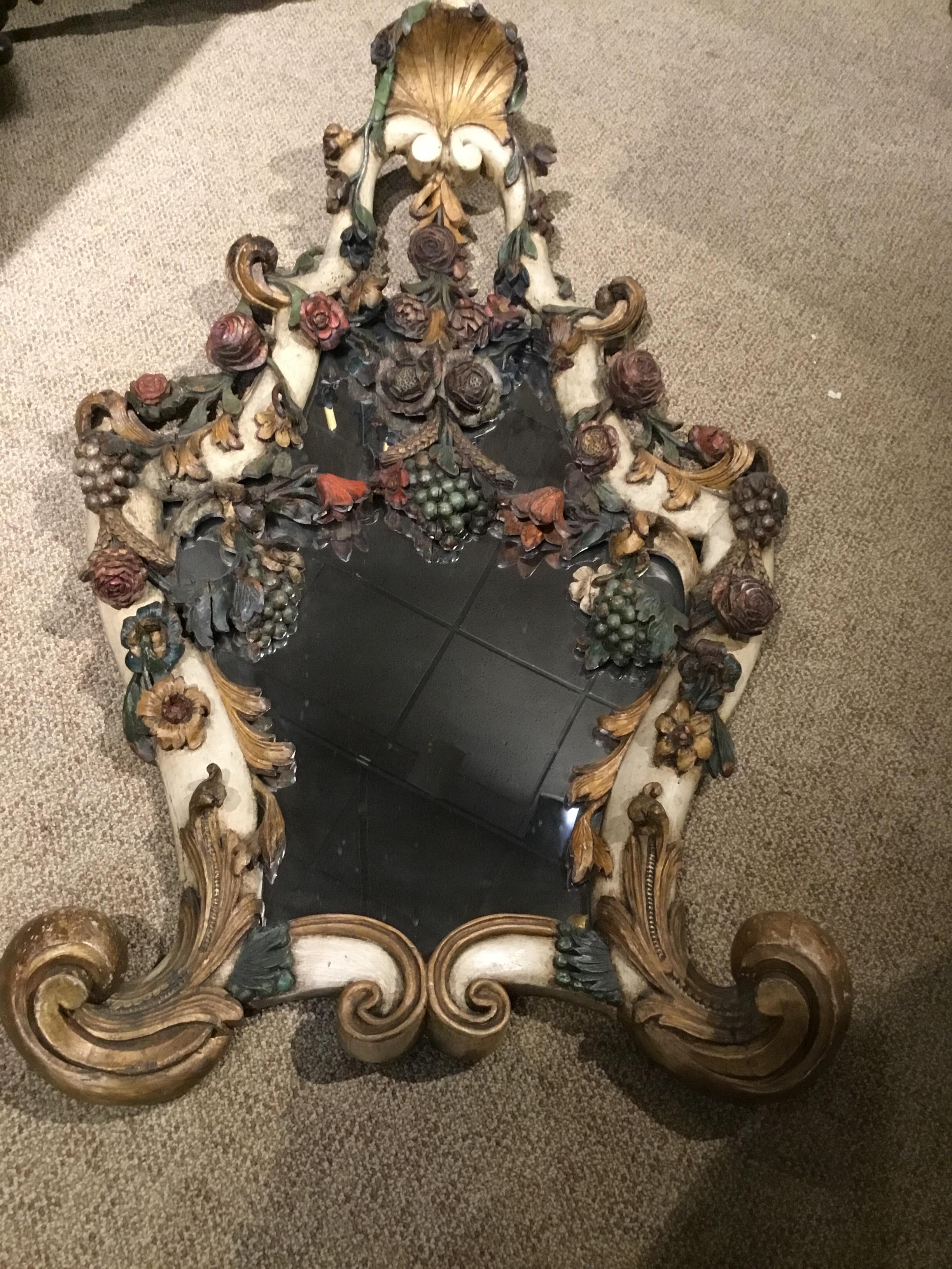 Beautifully hand carved Frame and polychromed in old world colors
Depicting flowers and fruits. Green, coral, gold and cream hues make
This mirror blend in perfectly with old world designs and interiors.