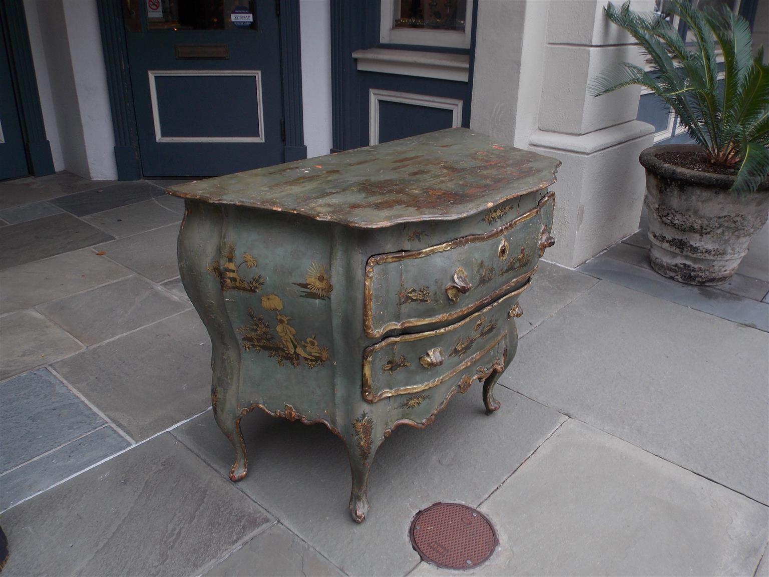 Venetian hand painted and gilt figural pagoda two-drawer commode with scalloped edge top, gilt carved shell form handles, and resting on a scalloped edge skirt with the original cabriole legs, Late 18th century.