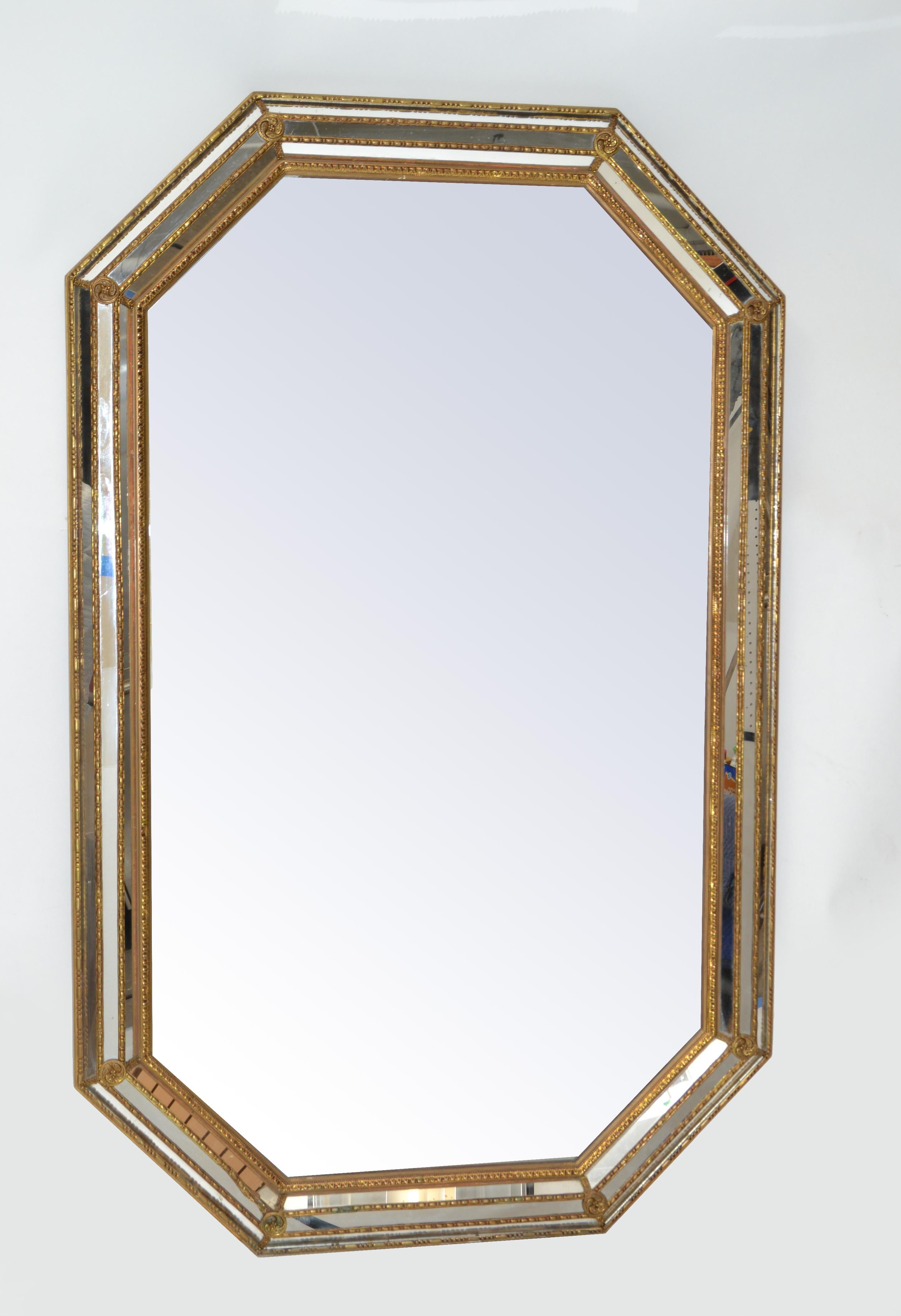 Venetian circa 1930 gilt wood wall mirror with Bohemian brass flowers and ornaments.
Can be hung vertical.
In all original condition with a clean break at the base, otherwise normal light wear.