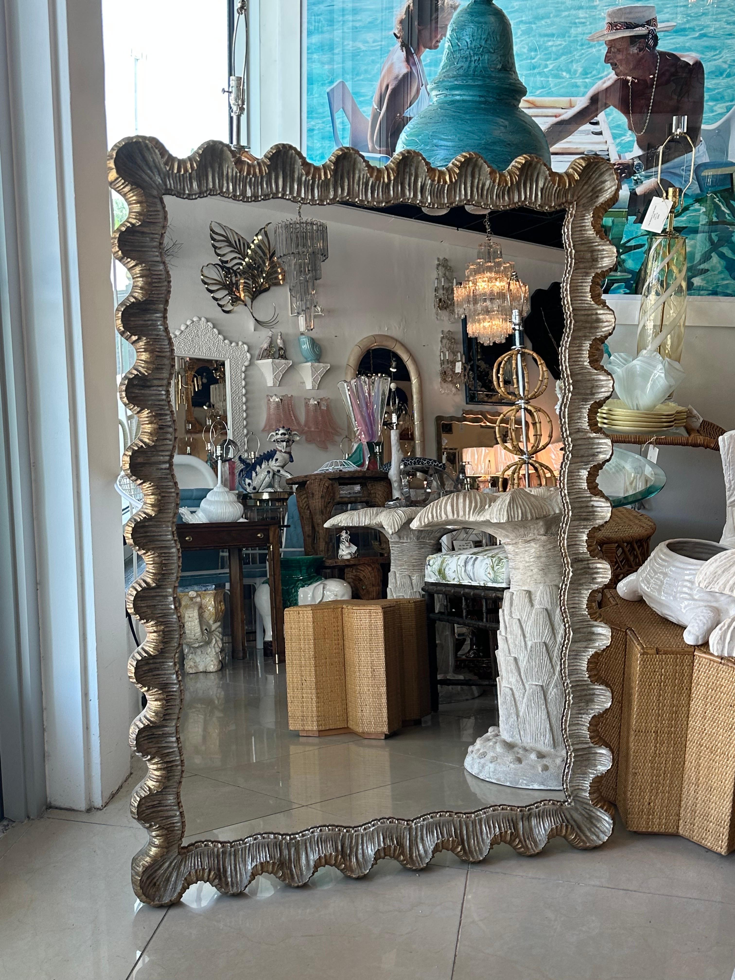 Beautiful vintage silver & gold gilt wood gesso carved ruffle scalloped wall mirror. Made in Italy. 1940s. Original mirror may have minor imperfections. minor patina and age to gilt and gesso. This can be hung vertical or horizontal. Dimensions: 52