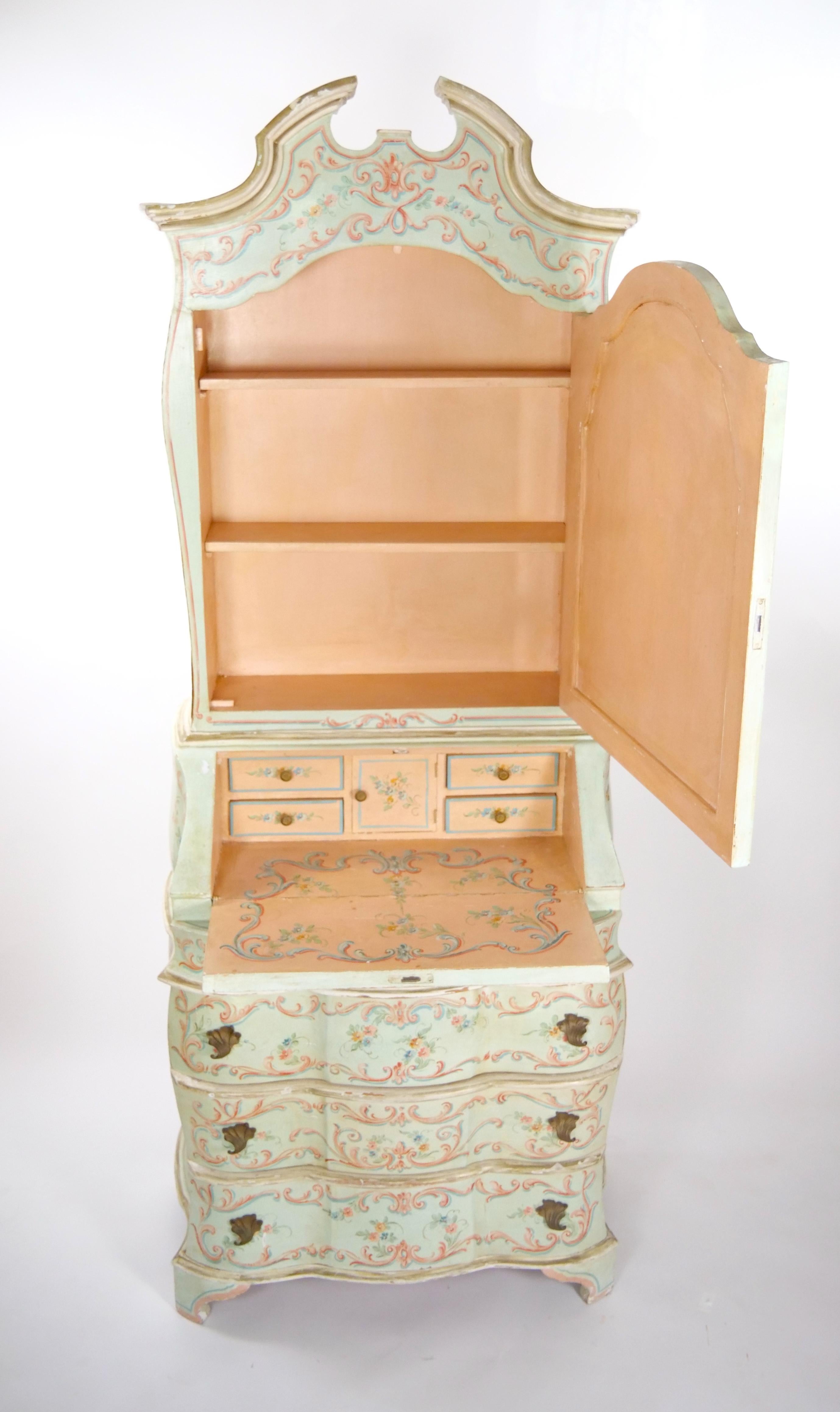 Embrace the timeless charm of this Classic Venetian Style Italian Polychrome Lacquered Hand-Painted two parts Bookcase, a piece of furniture that exudes both artistry and history. The exquisite hand-painted Venetian wreath decoration and parcel gilt