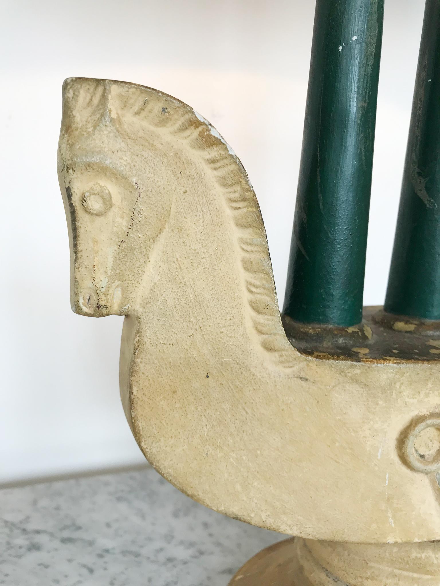 A Venetian painted plaster lamp in the form of a horse/vessel. Triple column in a painted dark green finish. Ovoid painted lamp shade in painted dark green, circa 1940s.

Height: 51cm (71cm including shade)
Width: 28cm (39cm with shade)