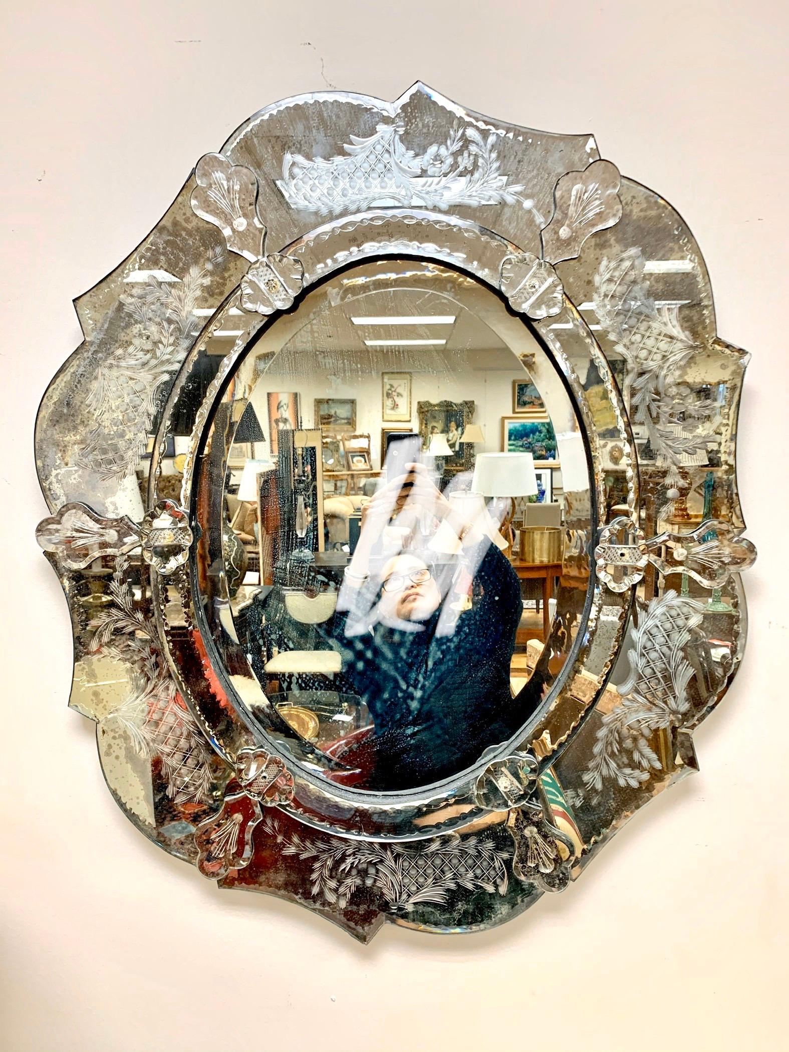 Elegant antique Venetian mirror, circa early 20th century, Italy. The mirror has some age appropriate wear but still retains is luster and has few losses to the patina. Please let all pictures. Ready to hang.