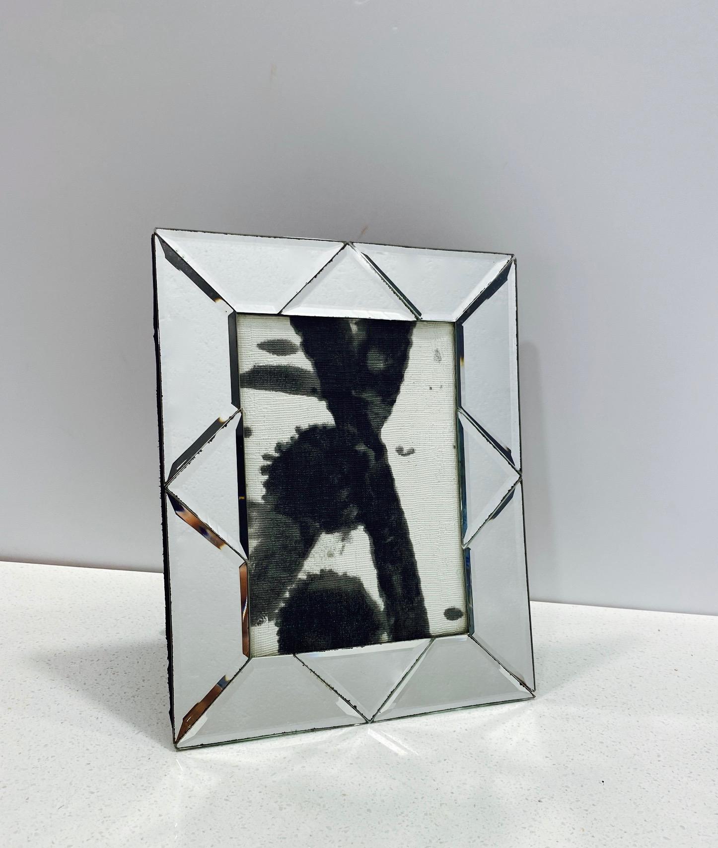Italian vintage picture frame with geometric design comprised of hand beveled mirrored glass. The frames measures 10