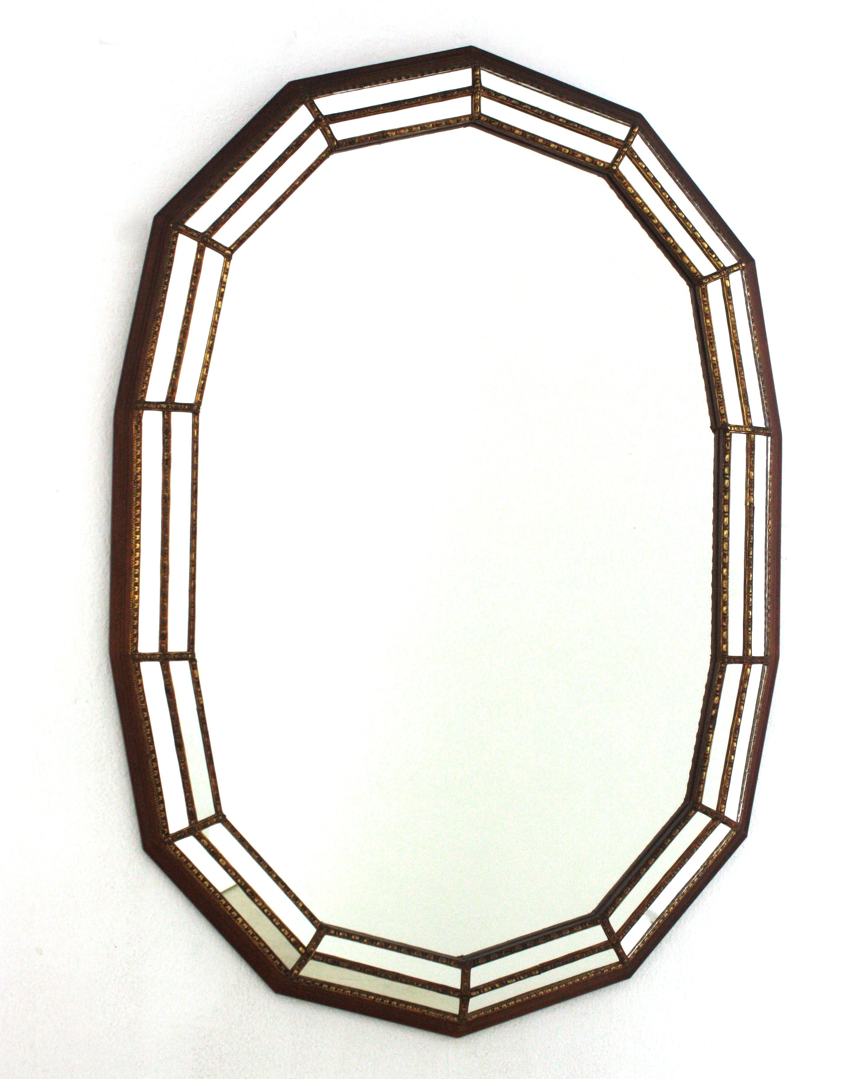 Venetian style Regency modern oval wall mirror with wood frame and brass accents, Spain, 1960s
Oval shaped mirror made of 14 sides. Triple mirror mosaic frame cased into a wood structure. The mirrored panels are adorned by brass classical