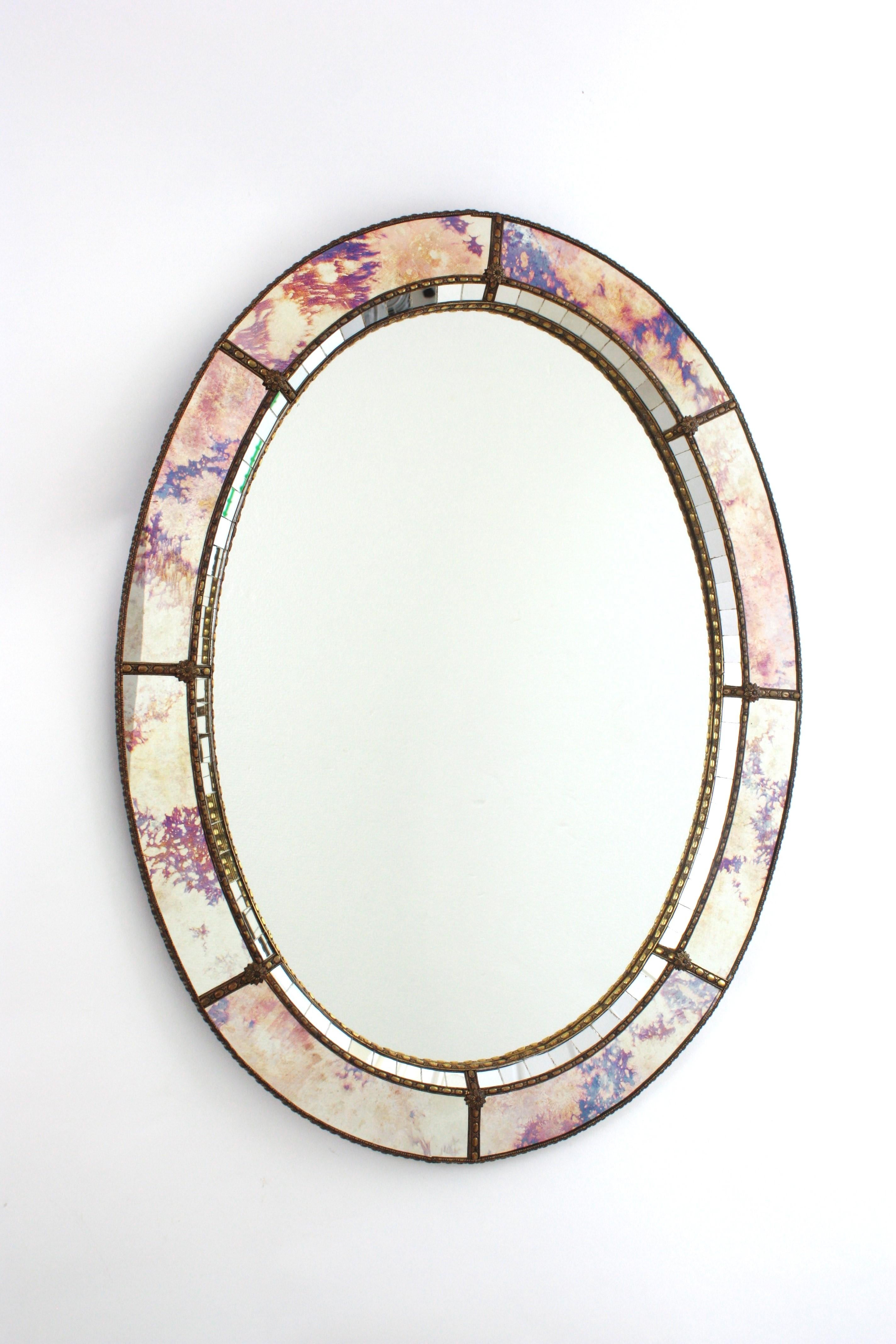 Superbe miroir ovale de style vénitien, Espagne, années 1960
Elegant miroir ovale de style vénitien Hollywood Regency avec panneaux en verre irisé et miroir.
Ce miroir glamour est doté d'un cadre à double couche en laiton. Forme ovale avec un cadre