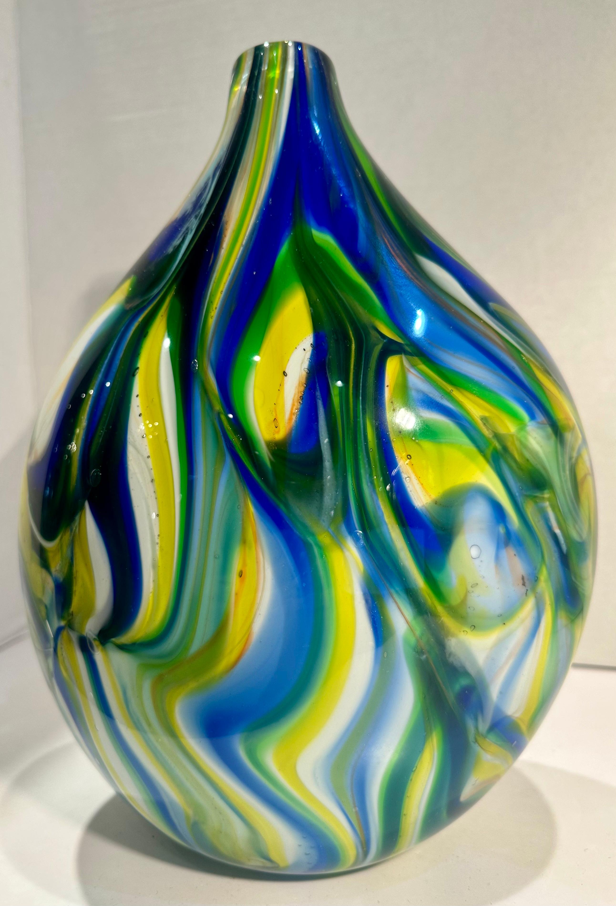 Bring modern art influences, captured in contemporary style, with this very artistic hand made and mouth blown in Italy, multi-colored abstract ovoid shaped vase. It features a gentle sloping bottle neck with bold freeform strokes of color, and the