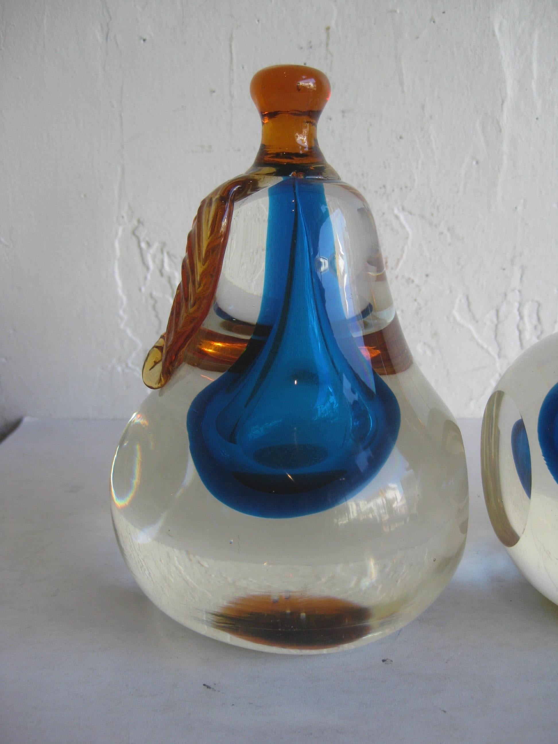 Beautiful set of matched Venerian Murano art glass Sommerso pear and apple bookends designed by Alfredo Barbini. These feature clear, blue and orange glass. They have one flat edge where they hold books. In excellent condition with no issues. Larger