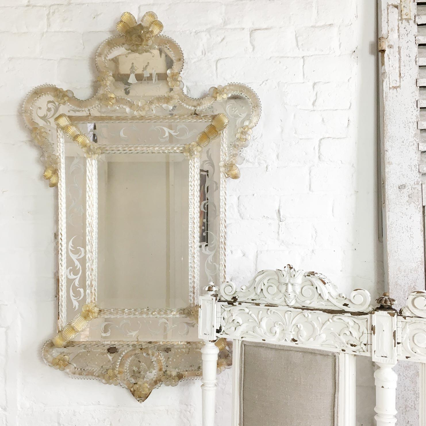 Italian Venetian Murano glass mirror circa 1930

Highly decorative wall mirror, handcrafted with handblown Murano glass.

This is a double bordered mirror, with hand twisted glass rods surrounding the adjoining etched mirror panels

The mirror