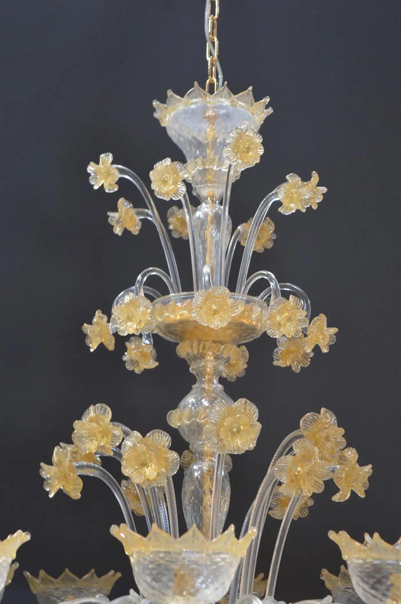 An exquisite Venetian Murano chandelier, handcrafted in Italy in the 21st century, showcasing the enduring elegance of Murano glass artistry. This luminous piece features delicately hand-blown glass elements, each infused with gold flecks that