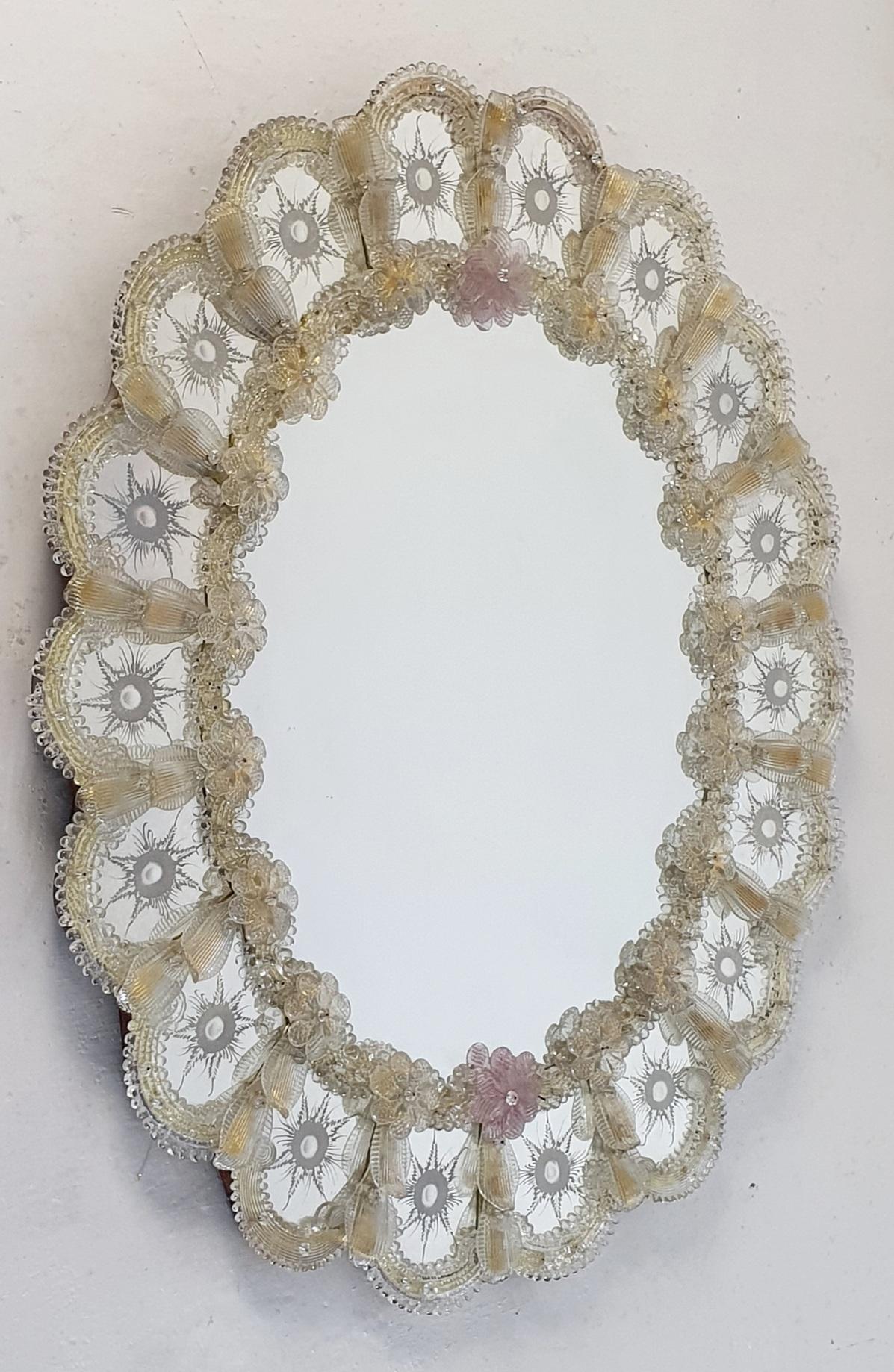 Oval Venetian mirror, made in beautiful clear and pale yellow Murano glass which is hand engraved. Made in the traditional way with the glass mounted on a wooden frame with a natural finish. Exquisite form and superb quality!