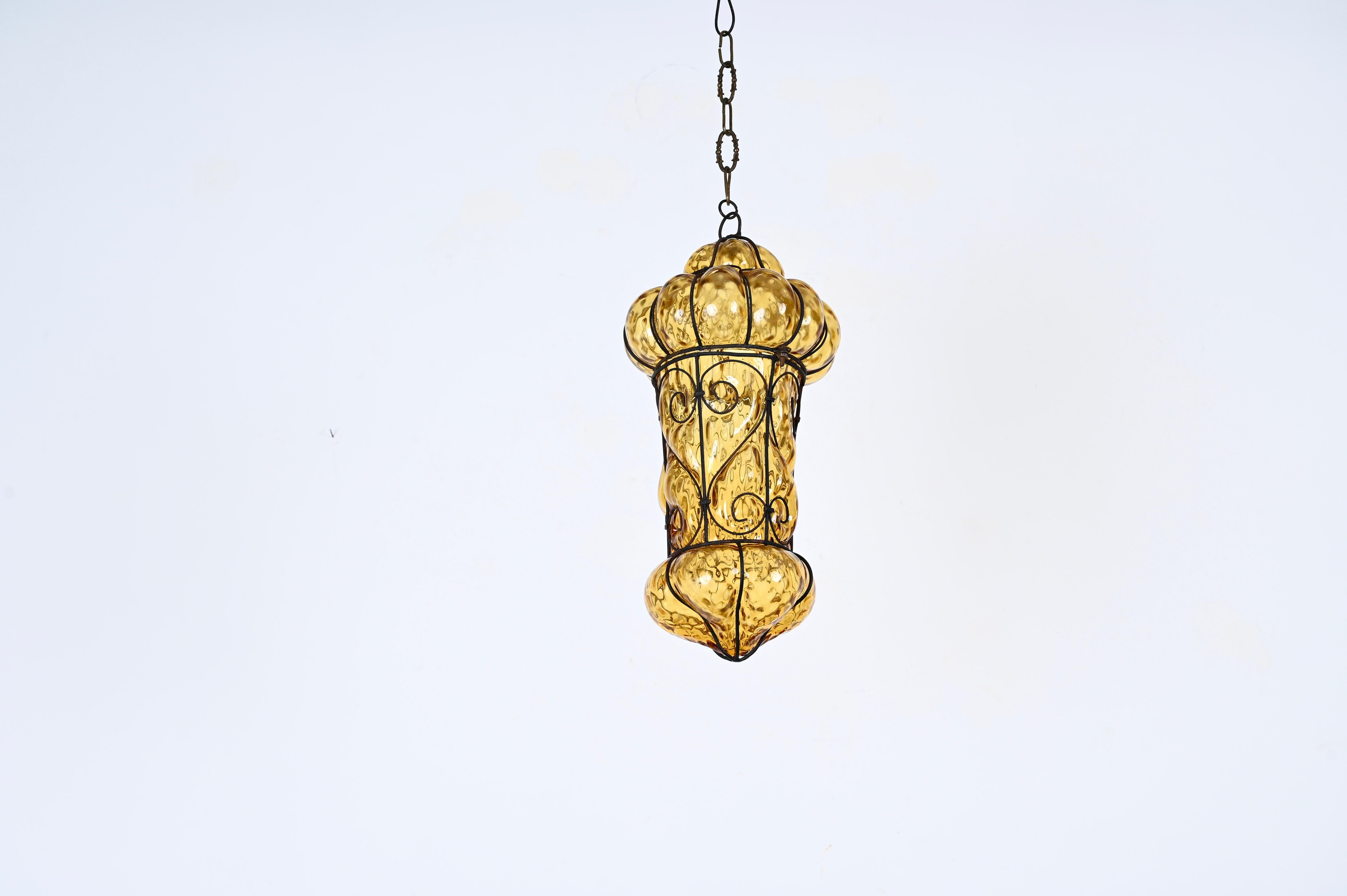 Fantastic Murano mouthblown amber glass chandelier with iron frame. Giorgio Seguso probably designed this wonderful piece in Venice,Italy during the 1940s.

This unique Venetian Murano glass bubble cage pendant has an oriental style and a 