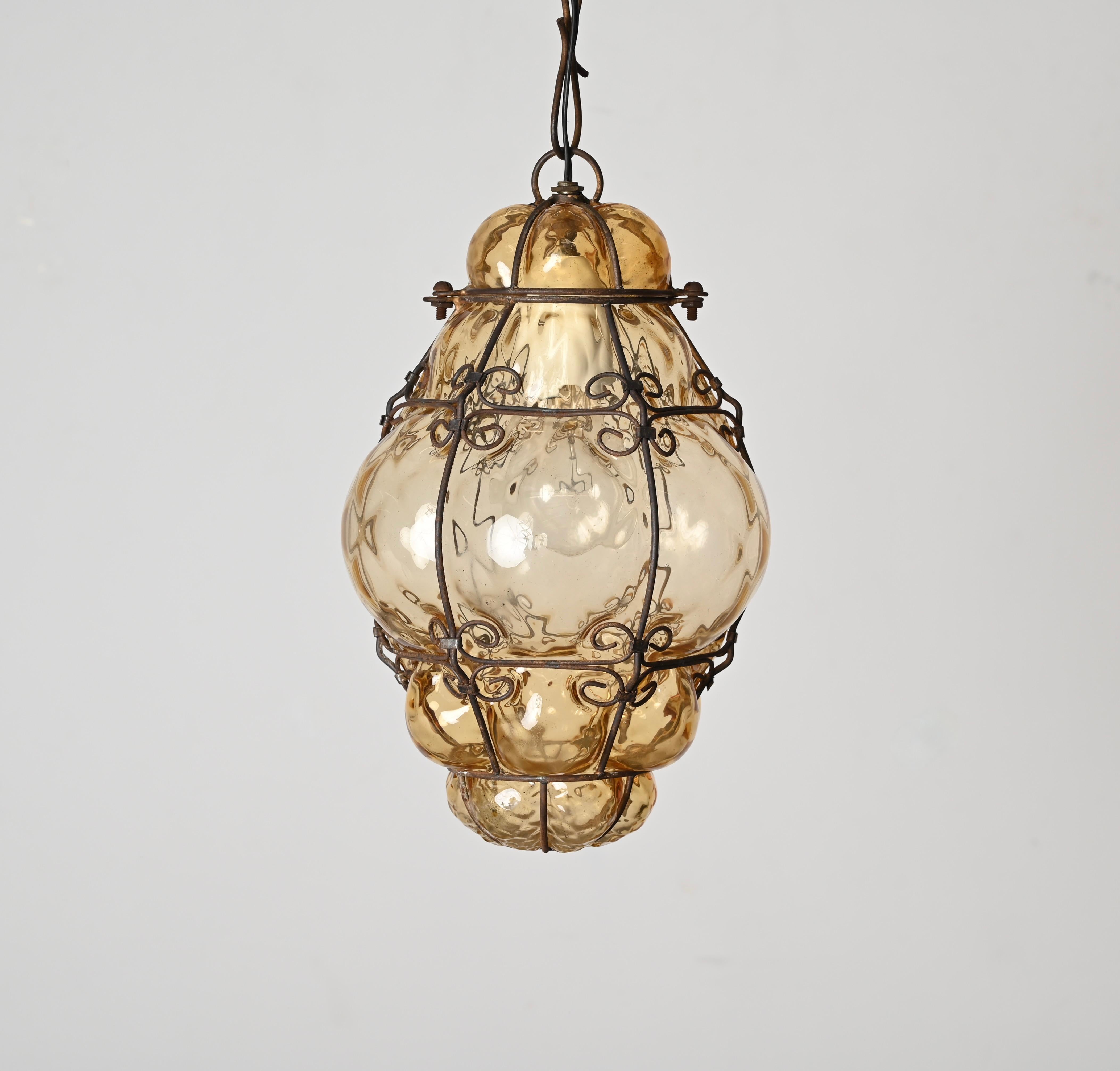 Fantastic Murano mouthblown amber glass lantern chandelier with iron frame. Giorgio Seguso probably designed this wonderful piece in Venice,Italy during the 1940s.

This unique Venetian Murano glass bubble cage pendant has an oriental style and a
